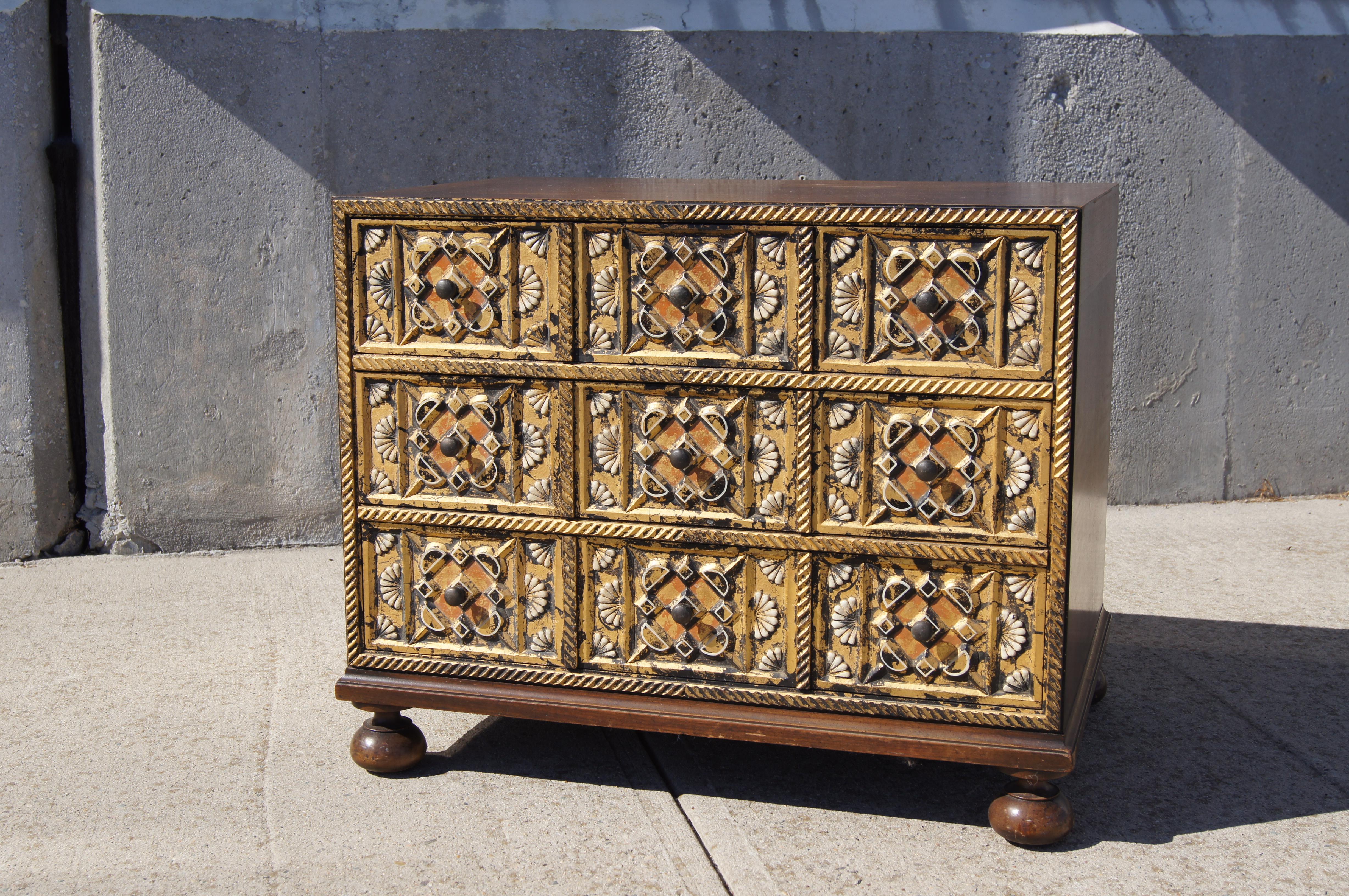 Created by the William A. Berkey Furniture Co. for its parent company Widdicomb, this charming revival dresser sets a walnut case on sturdy round feet. The three drawers feature ornately carved, gold-leafed fronts.

Maker's mark inside drawer.