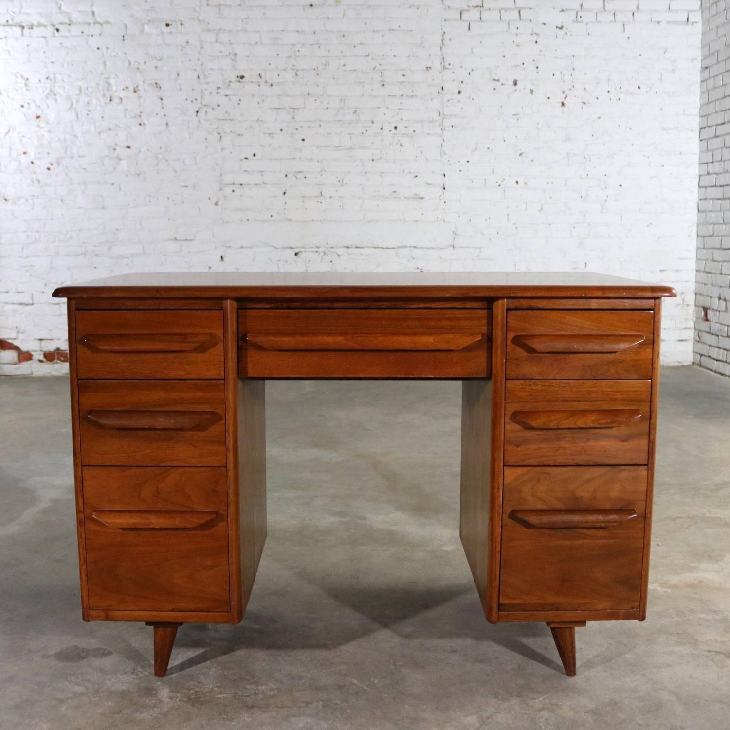 Handsome walnut writing desk in the manner of Carl Bissman’s mid-century modern pieces. It is in wonderful vintage condition with minor wear from age and use. See Photos. Circa 1950s.

An exceptionally beautiful mid-century modern writing desk done