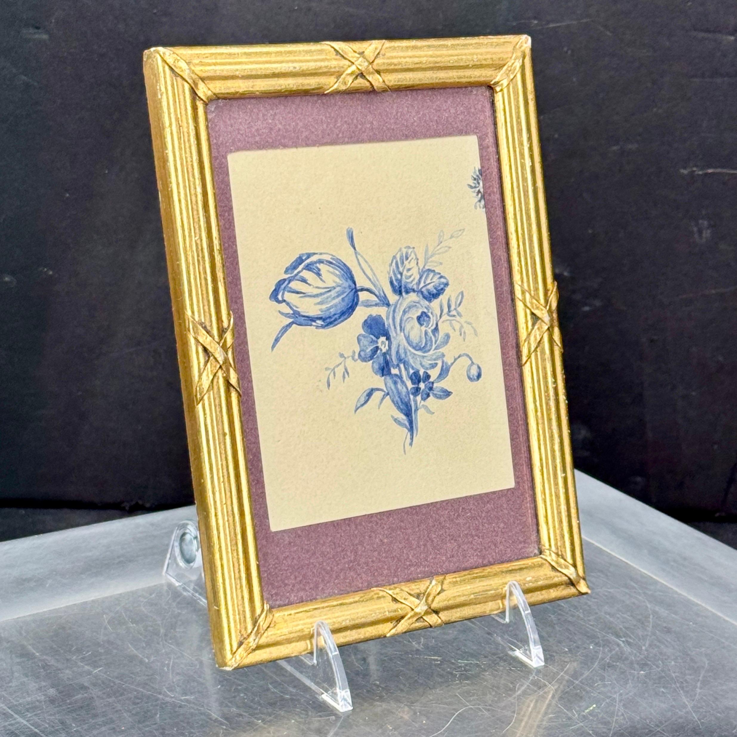 Very charming small rectangular artwork in a gilt wood ribbon frame. This watercolor featuring blue roses is from the 1920's would look fantastic as part of a gallery wall or certainly a stand alone piece. 