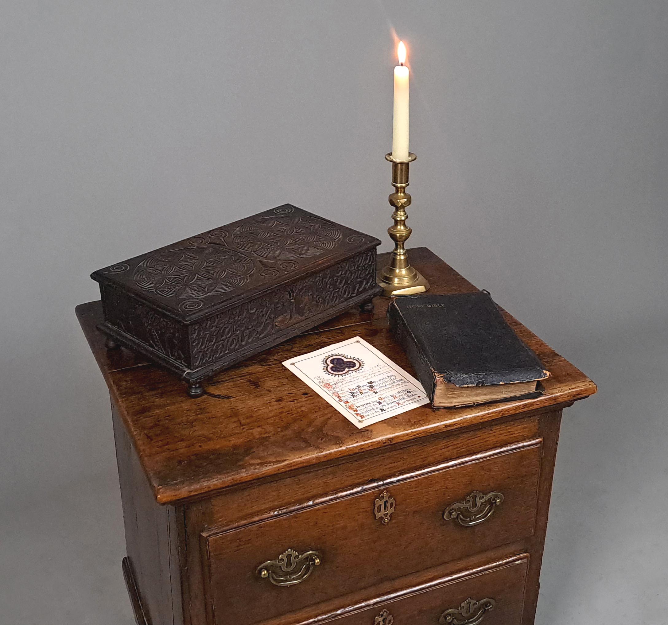 A very pretty, small oak box intricately carved to all four sides.   The front centred with a goose and lion rampart flaning a tree.   And panels caved with names and the date Anno 1722.  The side panels carved with stylised tulips, a ladder leaning
