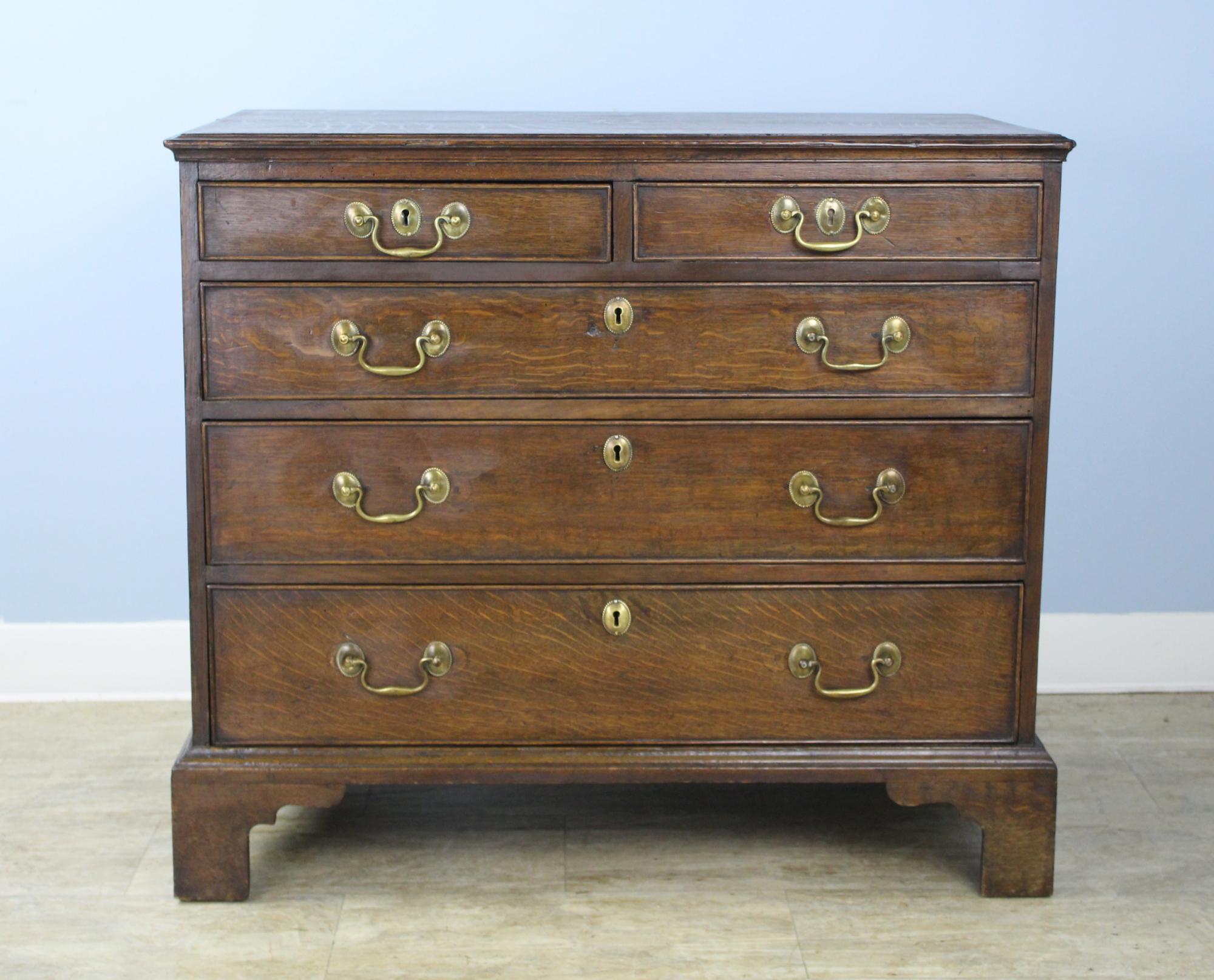 A lovely early welsh chest in a great smaller size. Two over three, the bureau has a very good color and patina, with fine oak grain on the top. The ogee feet are original, as are the drawers' cockbeaded edges.
