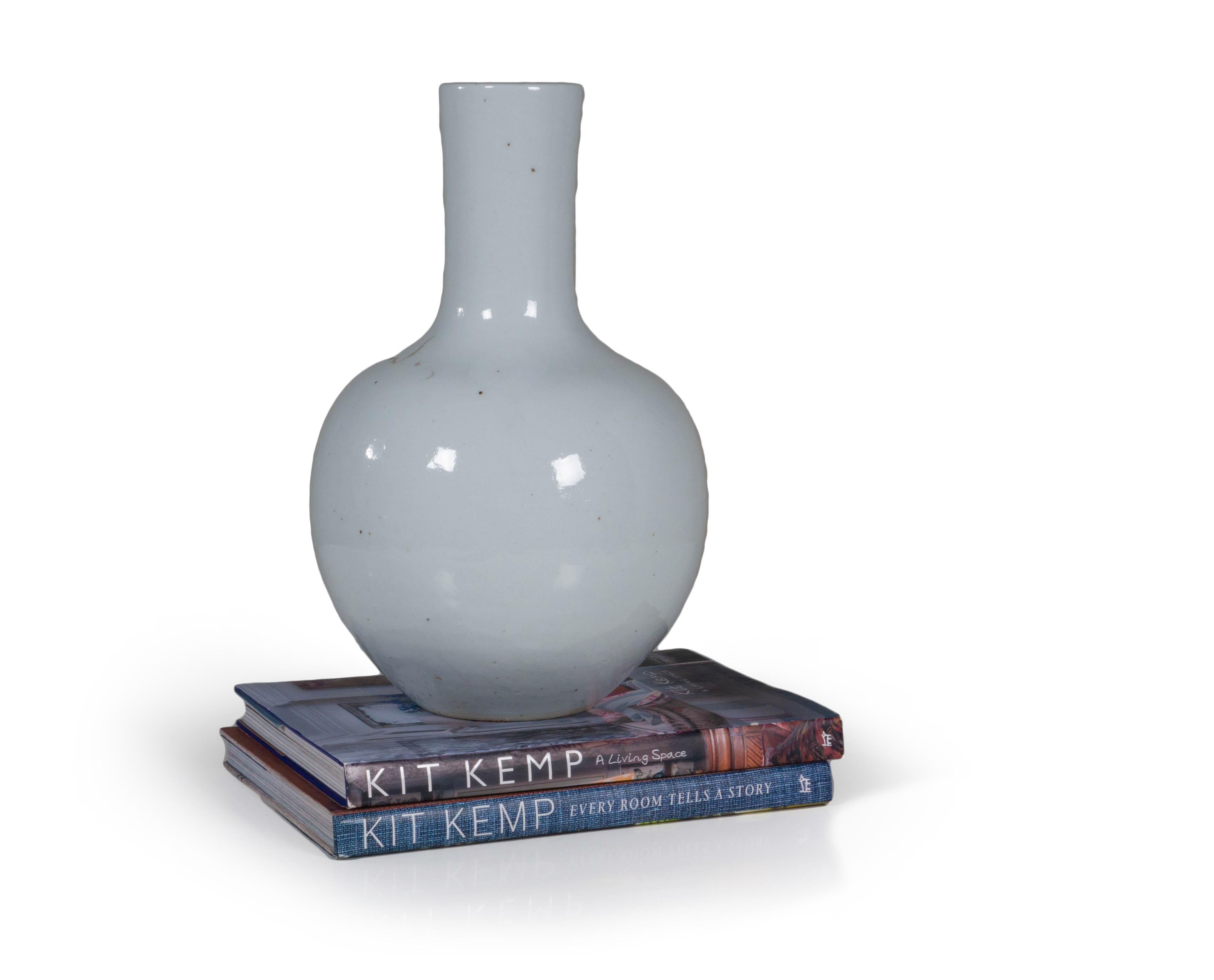 A modern take on the classic vase, this white ceramic version is a versatile piece for any decor. Designed with a wide base, this design makes it perfect for pairing with larger arrangements. This elegant white ceramic vase is finished with a glow