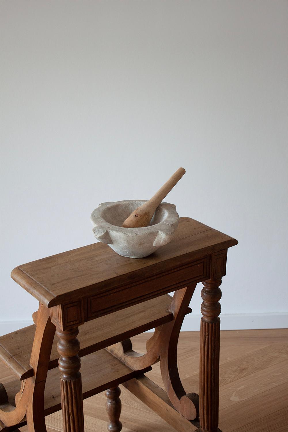 This small antique French mortar was sourced in the south of France. It's an iconic and traditional kitchen object that is found all over France. Its traditional use was and still is to grind seeds and herbs. 
This kitchen mortar will instantly add