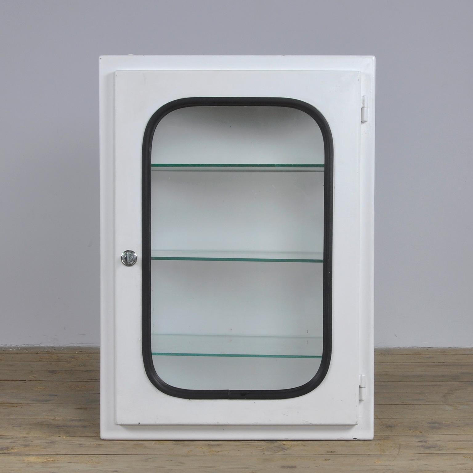 This medicine cabinet was designed in the 1970s and produced, circa 1975 in Hungary. It is made of iron and glass and is held by a black rubber strip. The cabinet comes with three adjustable glass shelves.
The cabinet was used in a hospital in