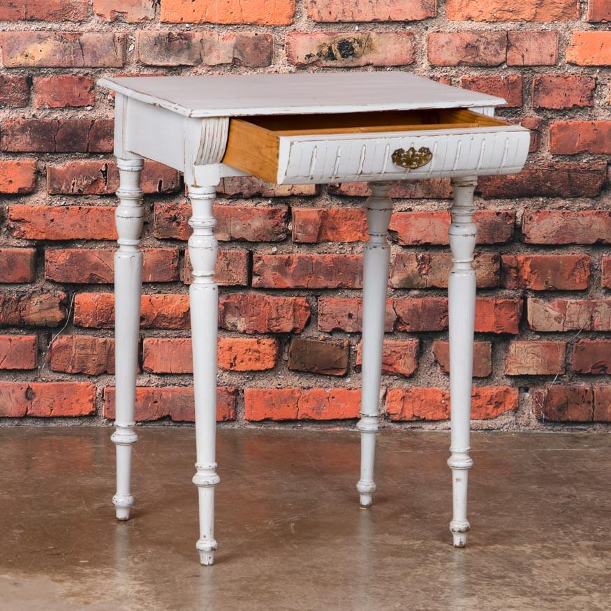 This antique side table from Denmark is simple but no less charming with it's turned legs and molded drawer front. The single drawer adds function and balance to this small country table that can be used in so many places. Please examine the close