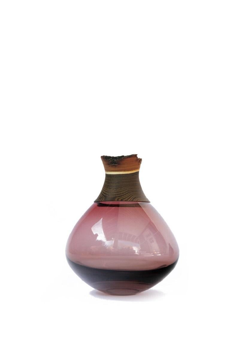 Small wine red pisara stacking vessel, Pia Wüstenberg
Dimensions: D 23 x H 30
Materials: glass, wood.
Available in other colors.

Pisara, 'drop' in Finnish, is a Vessel striking by its simplicity and exclusive palette of pastel and vivid