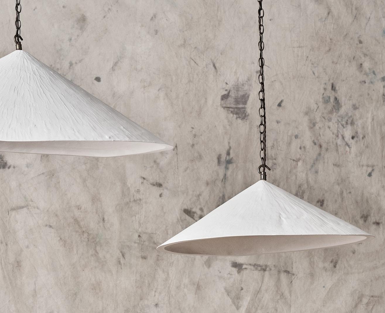 Our bestselling Wobble Light offers a distinctive and modern aesthetic whilst retaining a hand crafted textured quality. 
The plaster material has a chalky soft look, which, combined with the angles and the wonky bottom edge make it a unique and
