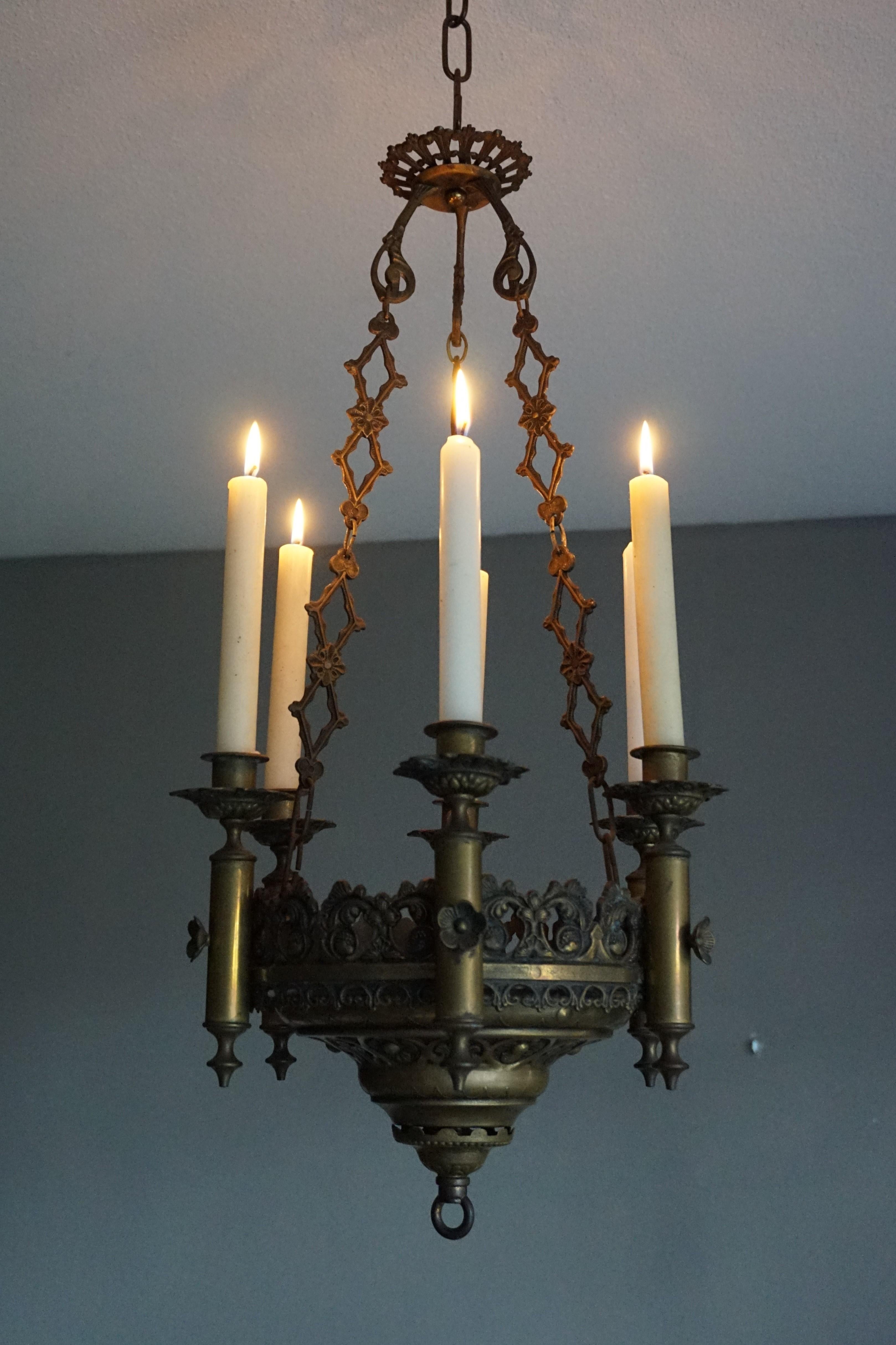 Beautiful and meaningful little work of religious art for a serene atmosphere.

This small size and compact church candle chandelier is perfect for creating a spiritual atmosphere. It comes with a number of stylized Gothic elements (such as the