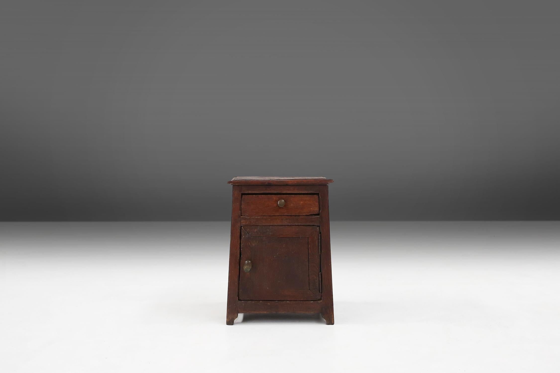 A rustic cabinet it features wit a small door and a single drawer. The cabinet is made of solid wood and has some nice details on the side. The drawer and door have a metal handle.

This cabinet can also be used as a stool.