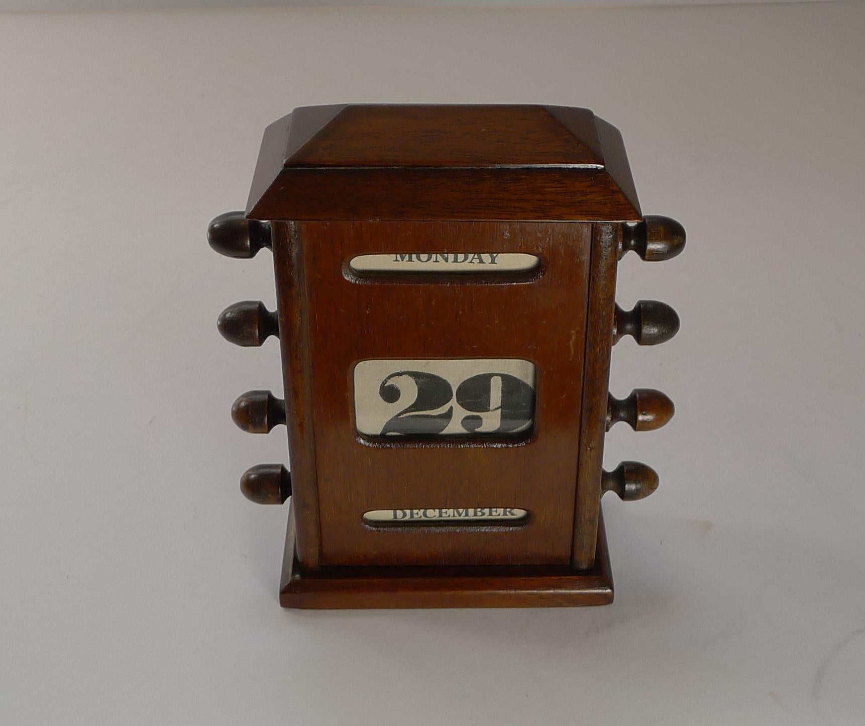 A fabulous Edwardian desk-top perpetual calendar; The calendar is operated by turning the keys each side to alter the day date and month, the panels protected by a glass front. 

Excellent working condition measuring 4 1/4