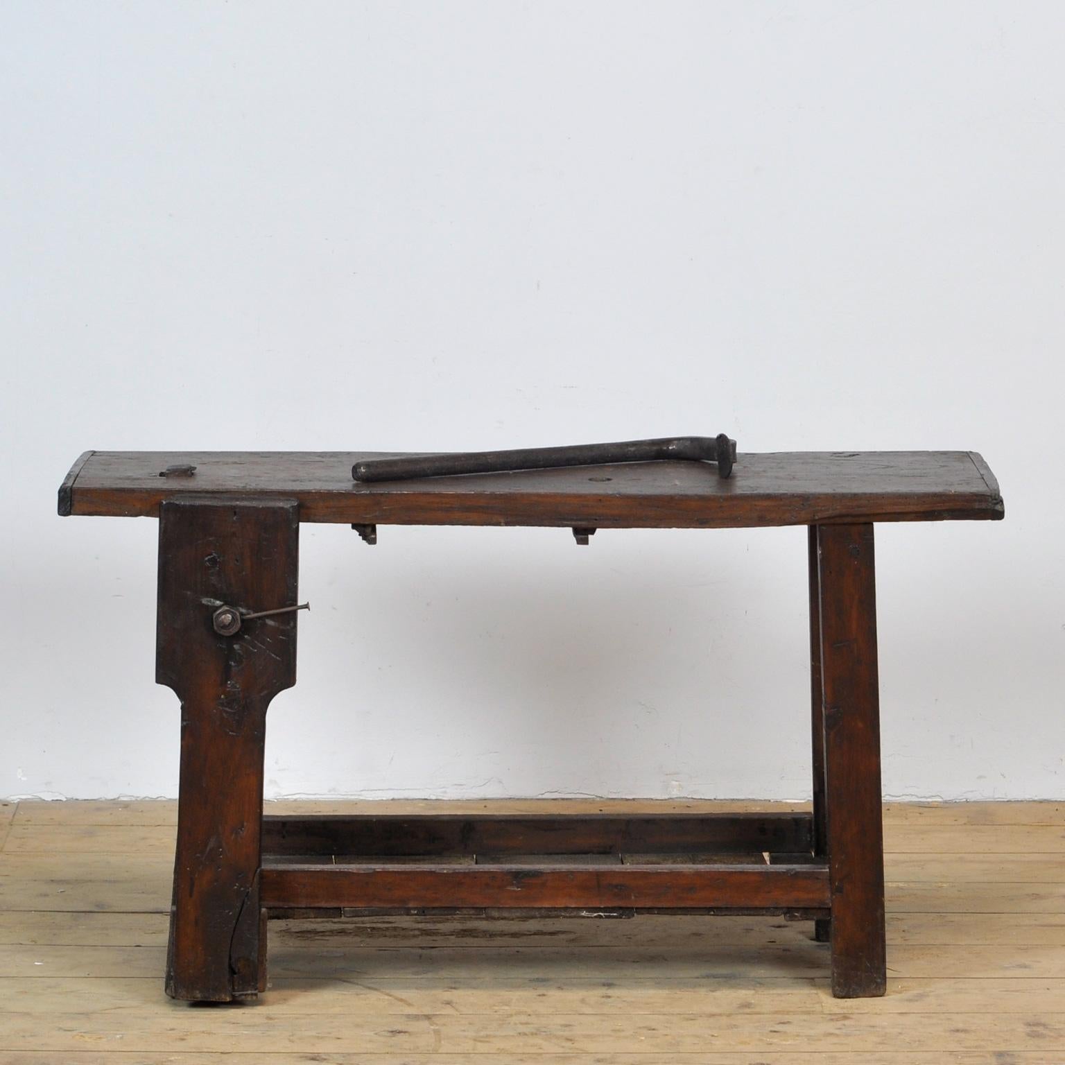 Small workbench circa 1930, made of oak and pine wood. The iron bar was intended to secure items. Of course it can also be used as a bench.