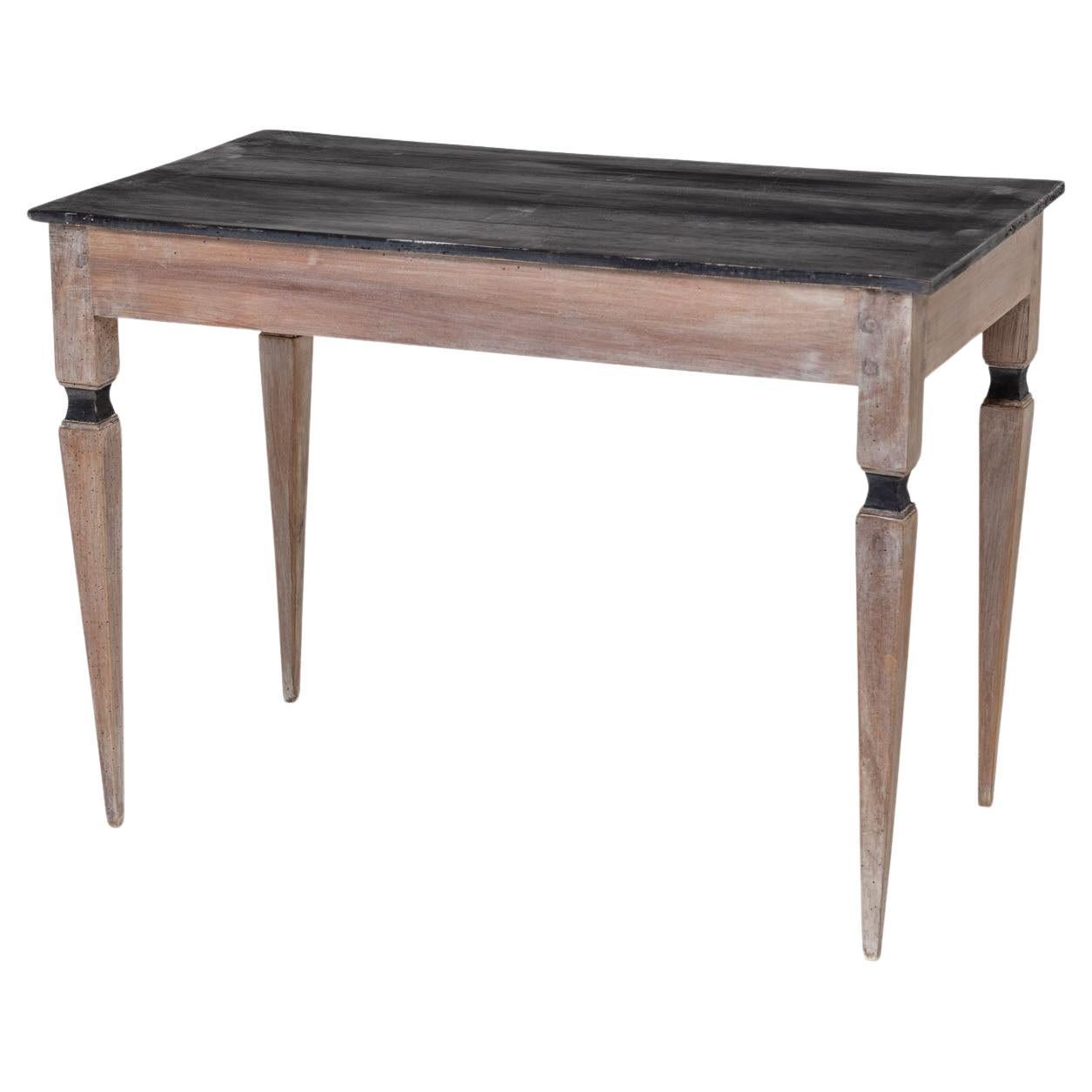 Small desk on high square legs with rectangular black table top and one drawer. The painting of the table is new and was then given an antique patina.