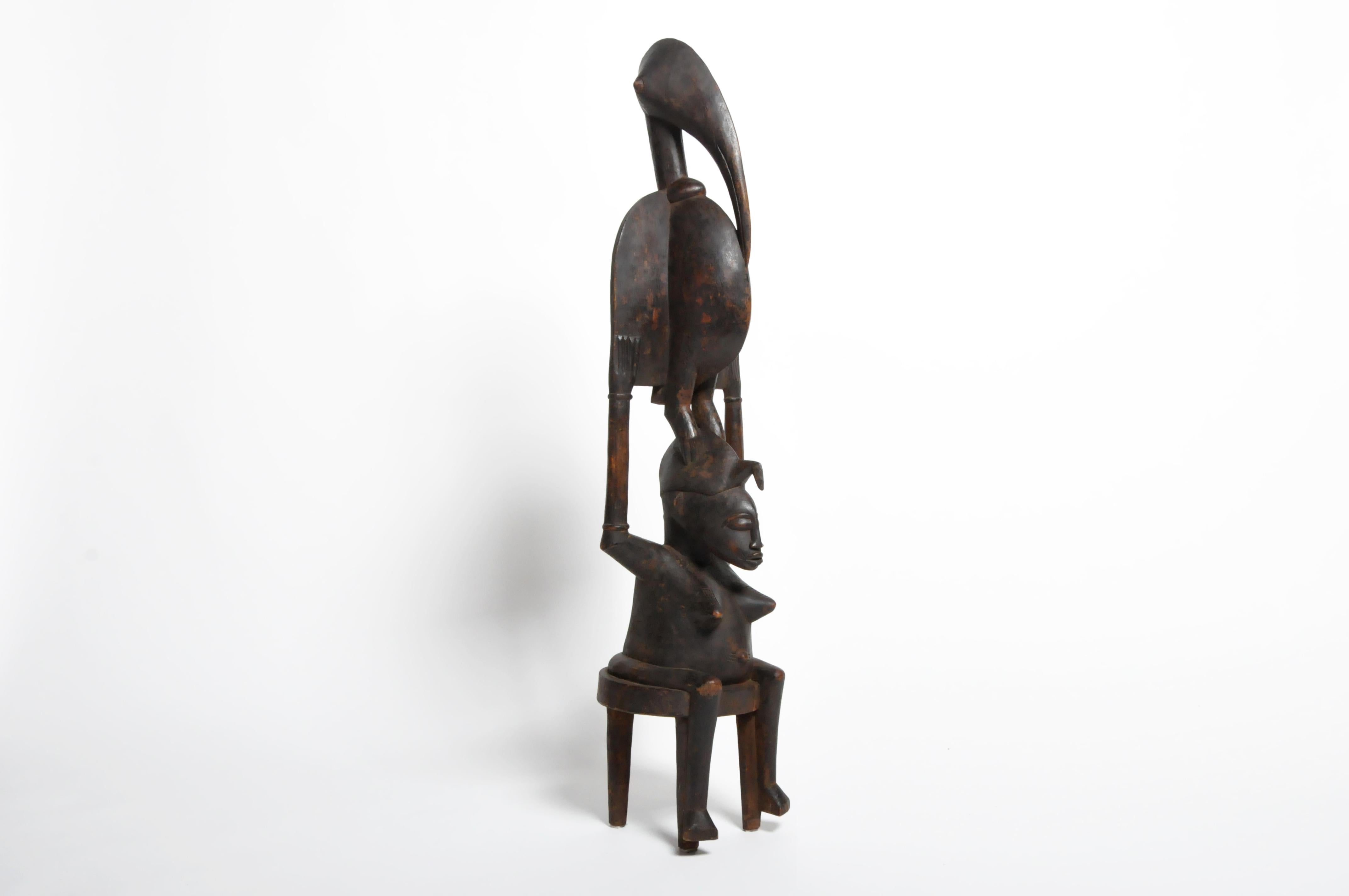 Figure of a Yoruba mother surmounted by a bird. The bird is a symbol of a mother in a transformed state. The Yoruba People inhabits modern day Nigeria, Togo, and Benin.