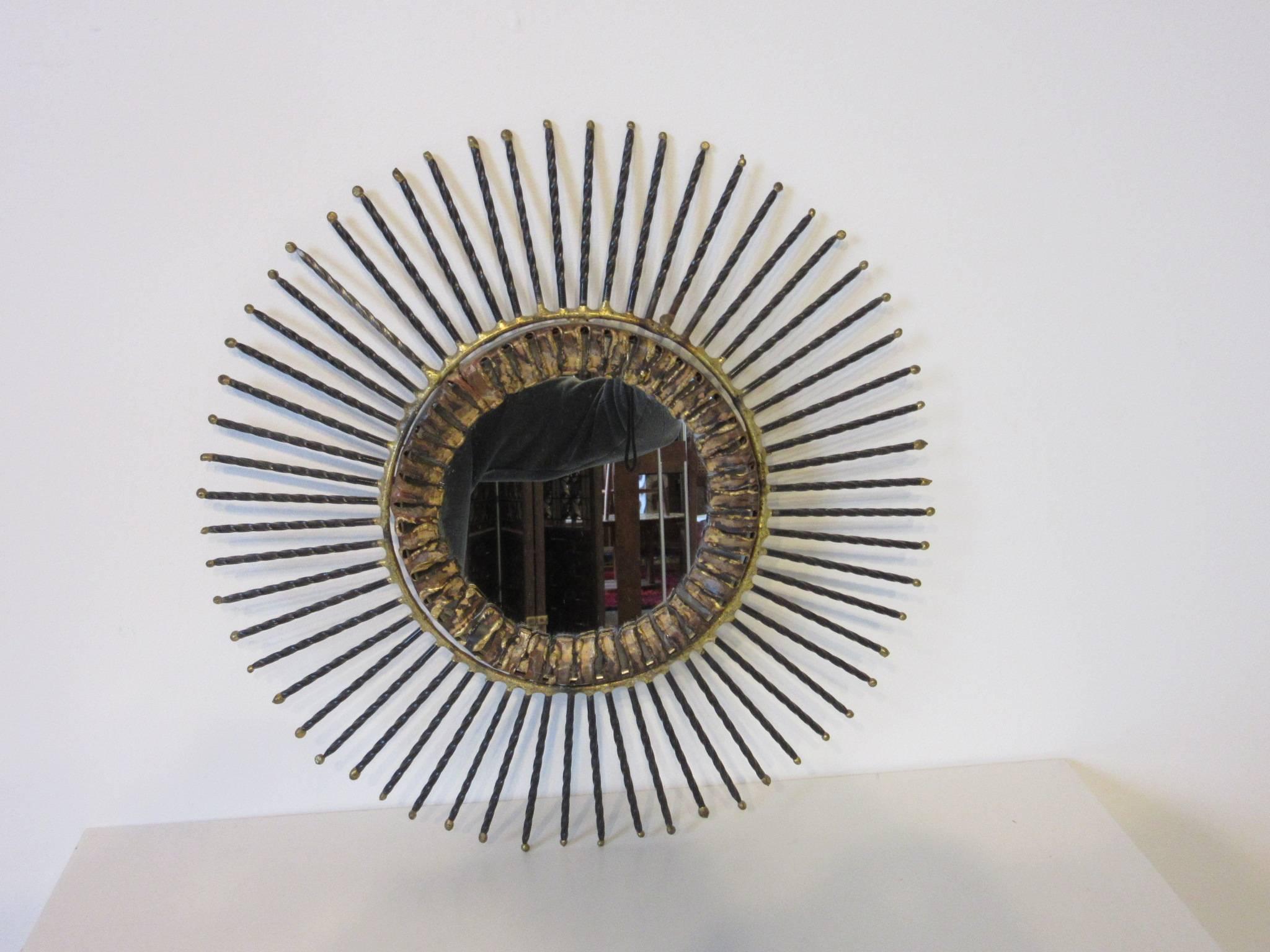 A smaller sized copper, brass and twisted steel mirror which has been welded and torch cut into a great Brutalist styled wall sculpture, ready to hang and artist made by Curtis Jere.