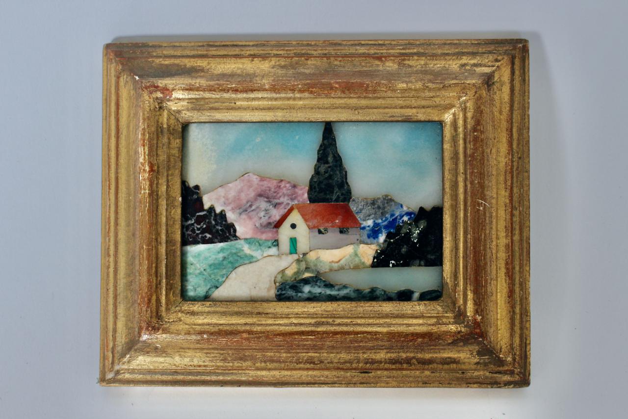 Florentine G. Ugolini Gilt framed hand cut natural stone mosaic wall hanging. Featuring a handmade rectangular, intricately detailed pastoral landscape scene by a pietra dura artisan in Florence, Italy, using colored semi-precious stones along with