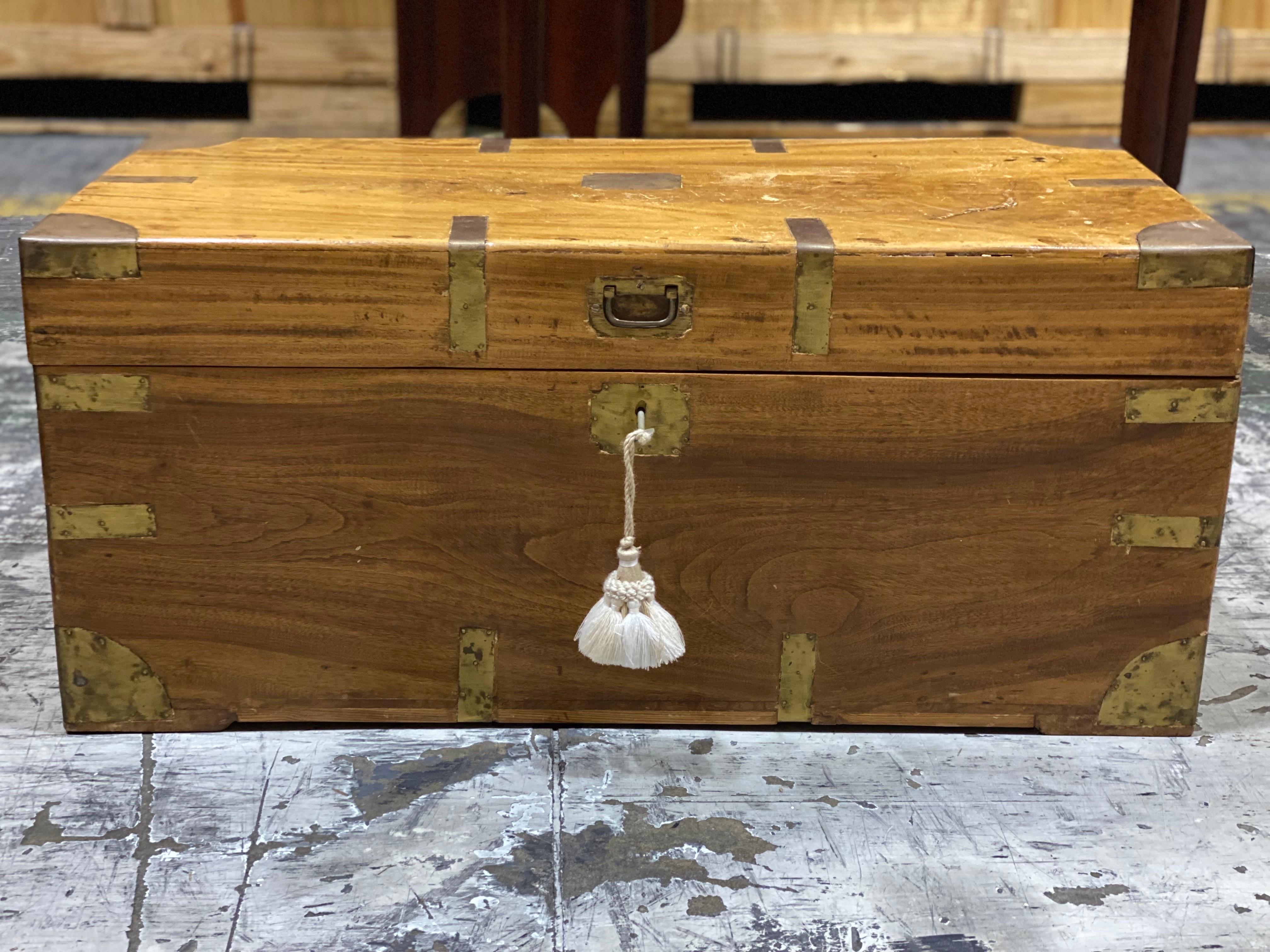 A smaller scale mid-19th Century Camphor Wood Military Campaign Trunk
Crafted from warm-toned wood, lined on the interior with Camphor wood, featuring distinctive brass corner fittings and handles. This chest combines functionality with historical