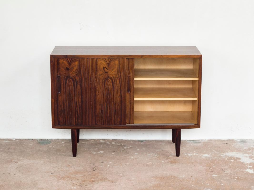 This smaller midcentury sideboard is designed and manufactured by Hundevad in Denmark in the 1960s. True high quality manufacturing in rosewood. The sideboard is stamped by the manufacturer in the back of the furniture. The sideboard is in very good