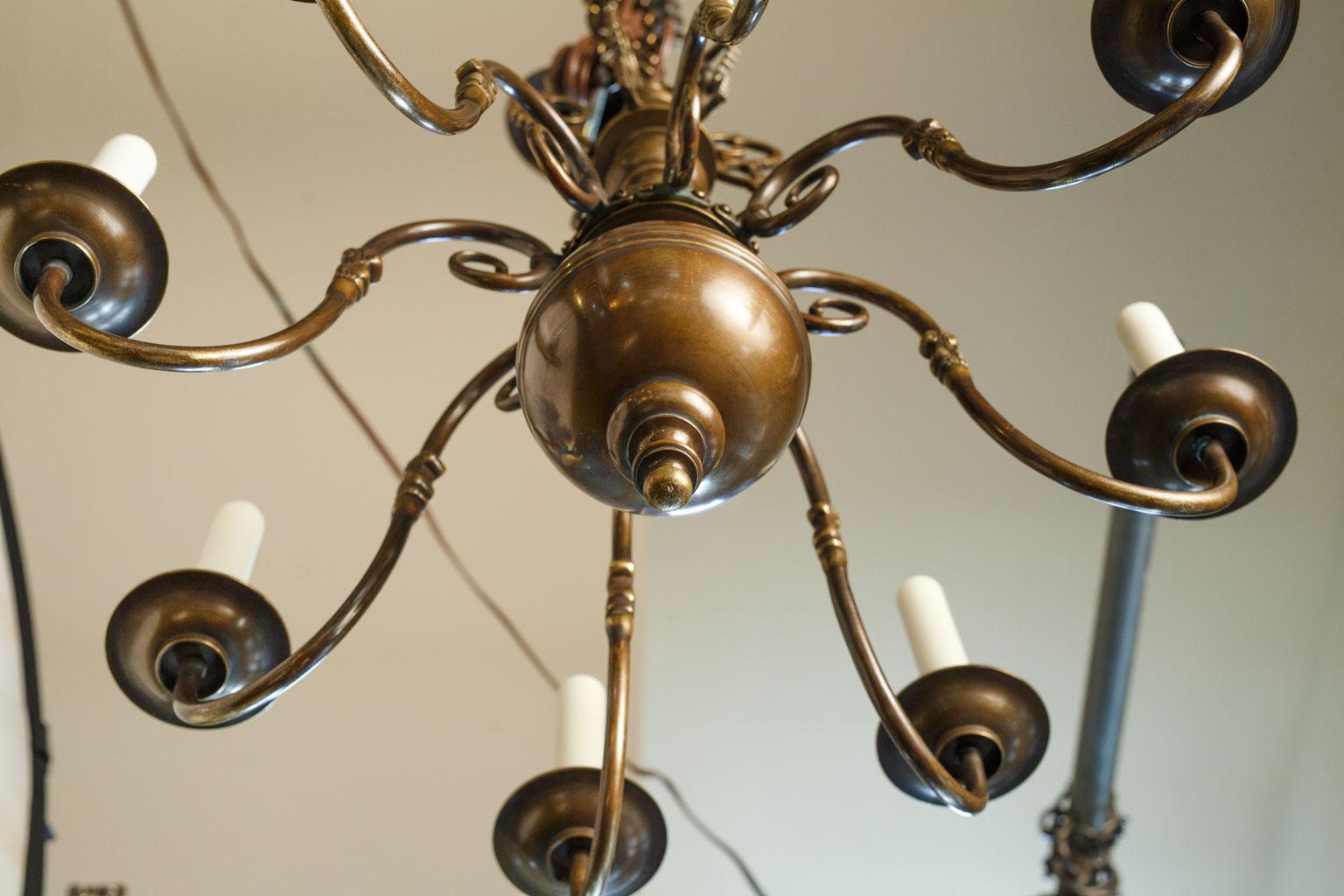 Smaller scale Georgian style chandelier in brass. Eight arms with candelabra-size sockets. Newly wired for use within the USA. Includes chain and a canopy.
