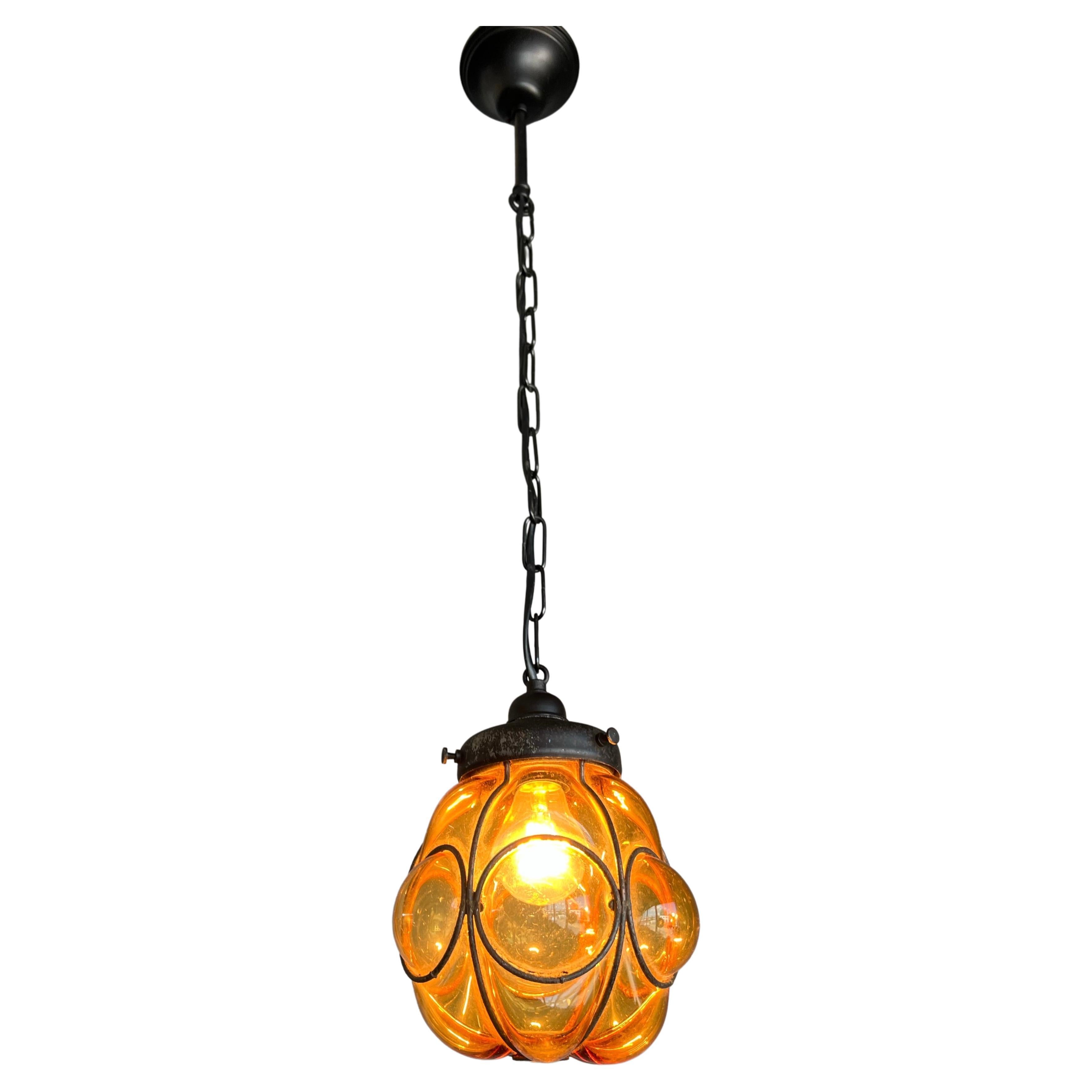 Smallest ever Venetian pendant in a hand forged wrought iron frame.

This adorable and antique Venetian pendant light is the smallest of its kind that we ever had the pleasure of offering. When it comes to condition, style and true workmanship
