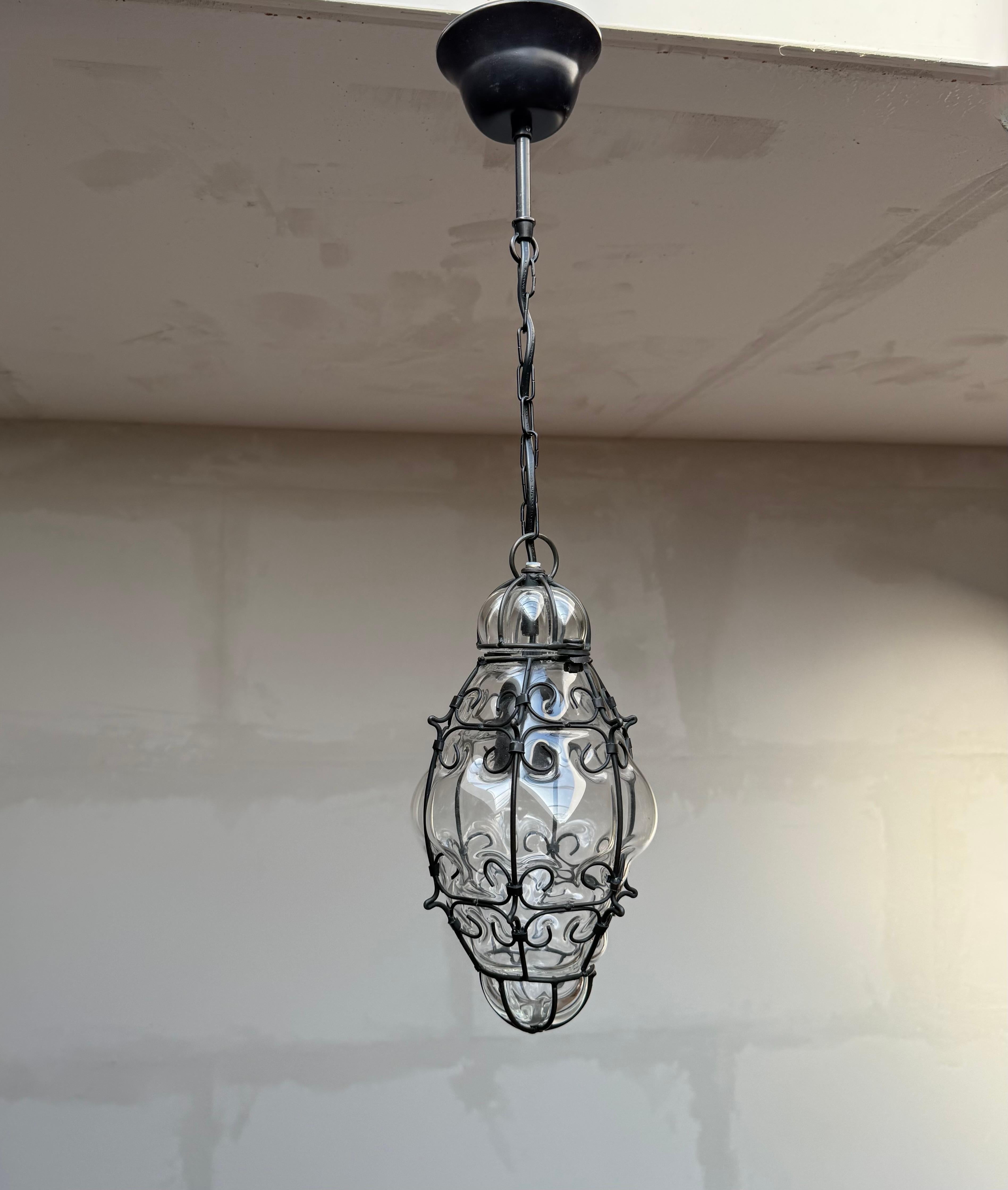 Smallest ever Venetian pendant in a real, hand forged wrought iron frame.

This adorable and antique Venetian pendant light is the smallest of its kind that we ever had the pleasure of offering. When it comes to condition, style and true workmanship