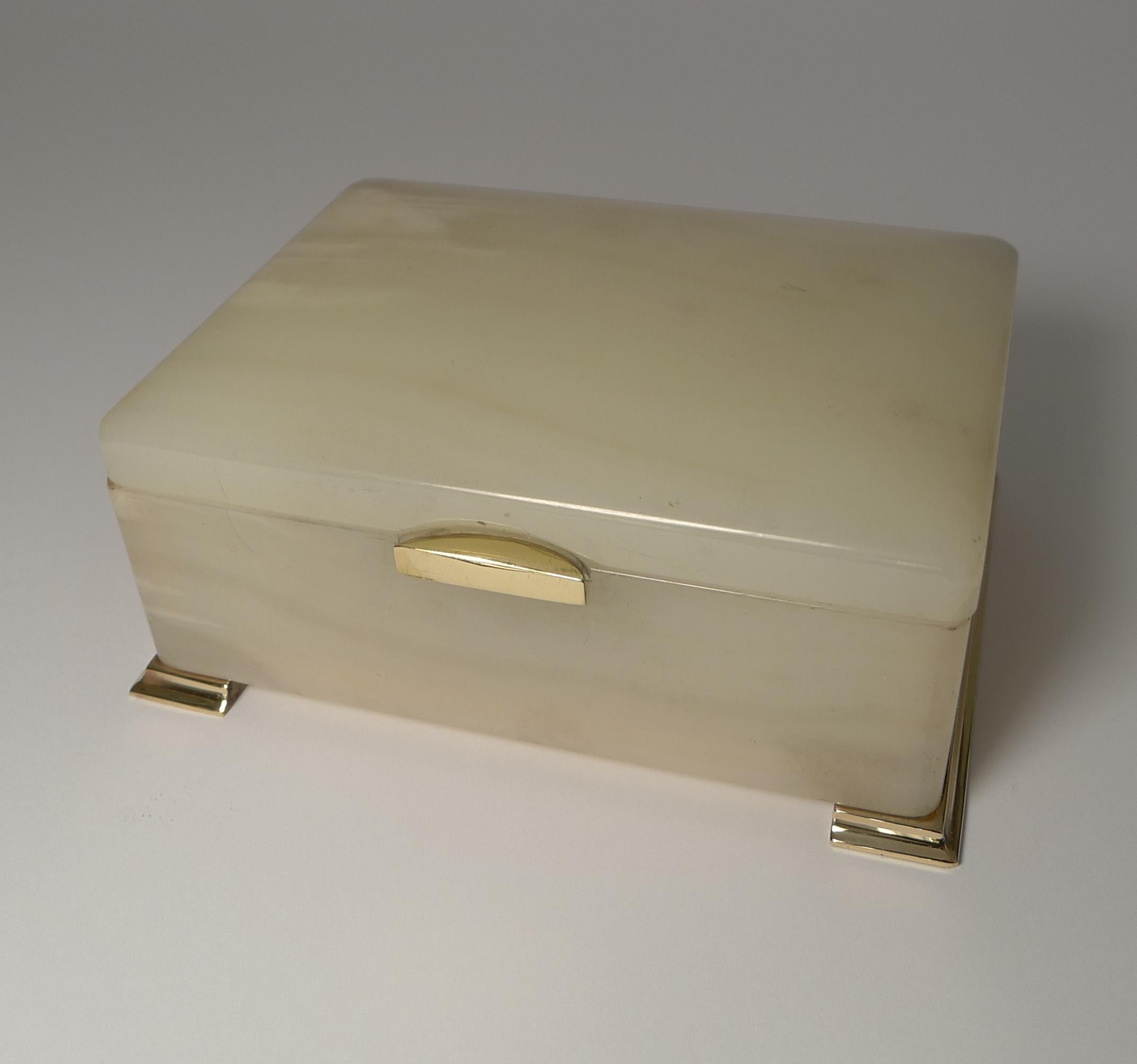 A very elegant box in white onyx with polished bronze fittings.

The box opens to reveal the signature for the well renowned London Patentees and Makers, George Betjemann. Marked on the hinge Betjemann's Patent 449335, made in England; the box