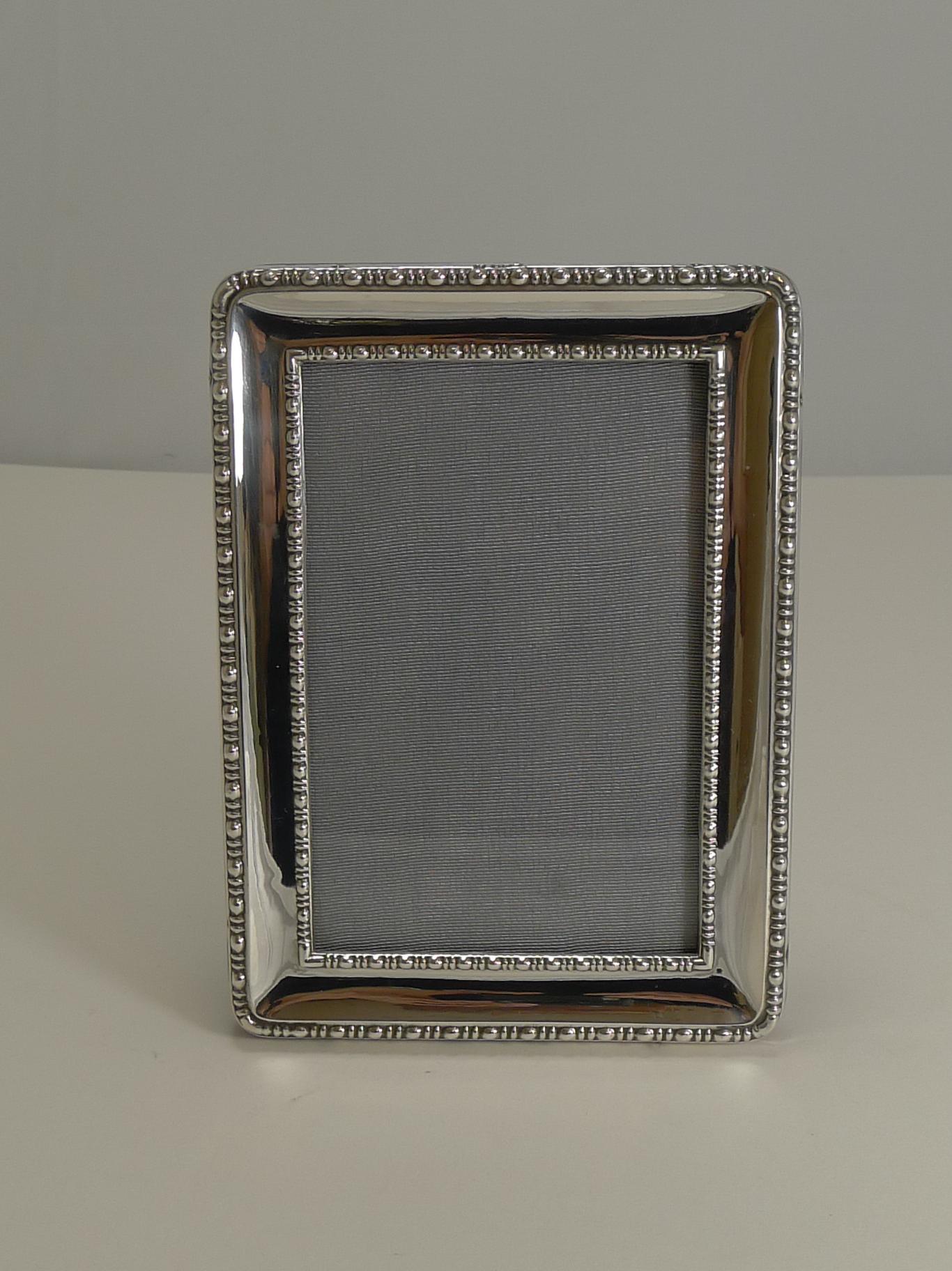 A superb and very smart antique English photograph frame, 100 years old this year with a full English hallmark for Sheffield 1918. The maker's mark is also present for the well renowned silversmith, James Deakin & Sons - John & William Deakin.

It