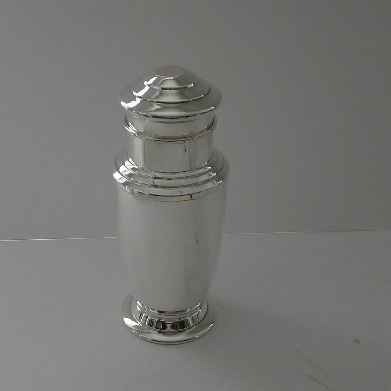 A superb, handsome and unusual silver plated cocktail shaker, very handsome and very Art Deco dating to c.1940.

Two pieces, with an integral strainer inside the shaker. Just back from our silversmith's workshop where it has been professionally