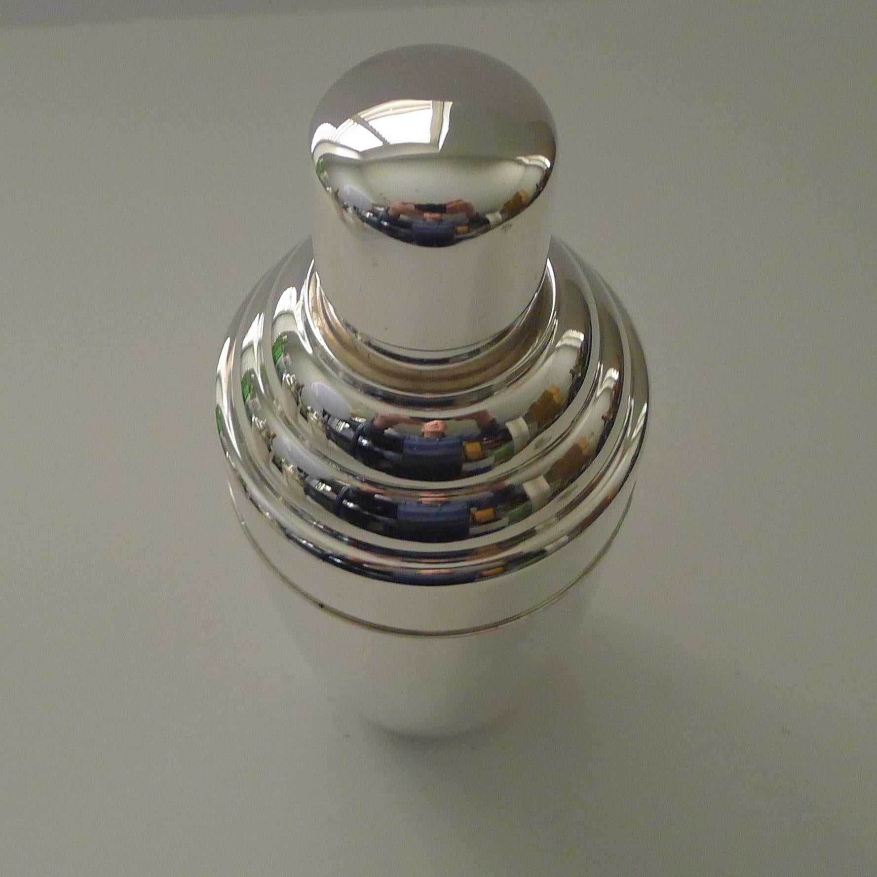 A very smart vintage silver plated cocktail shaker, an unusual shape and a good size.

Just returned from our silversmith's workshop, where it has been professionally cleaned and polished, restoring it to it's former glory.

Fully marked on the