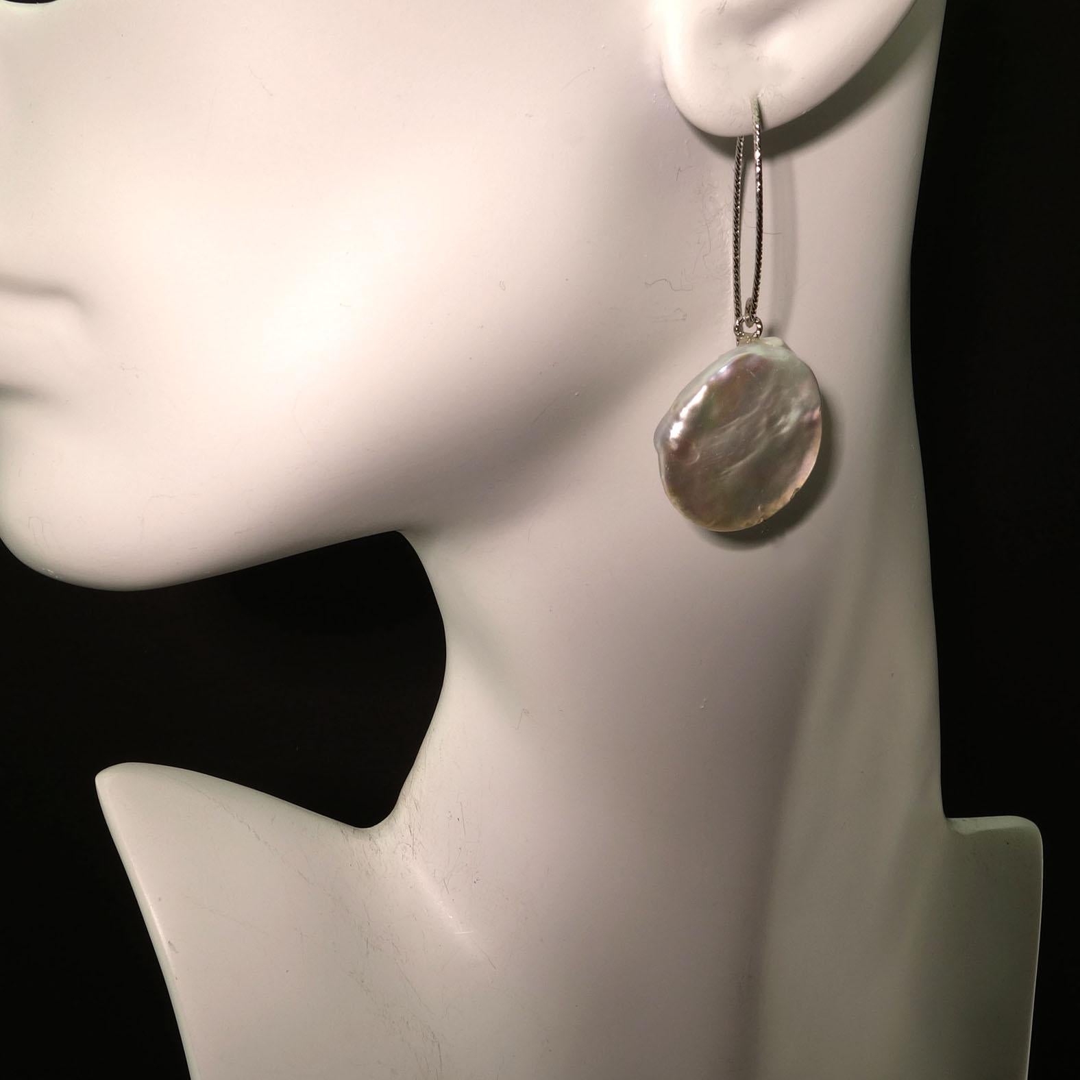 Handmade earrings of white iridescent Coin Pearls swinging from Sterling Silver twisted wires.  These lovely white Coin Pearls are a generous 20 MM and iridesce pink and blue! These elegant earrings are perfect for all your teleconferencing! And are