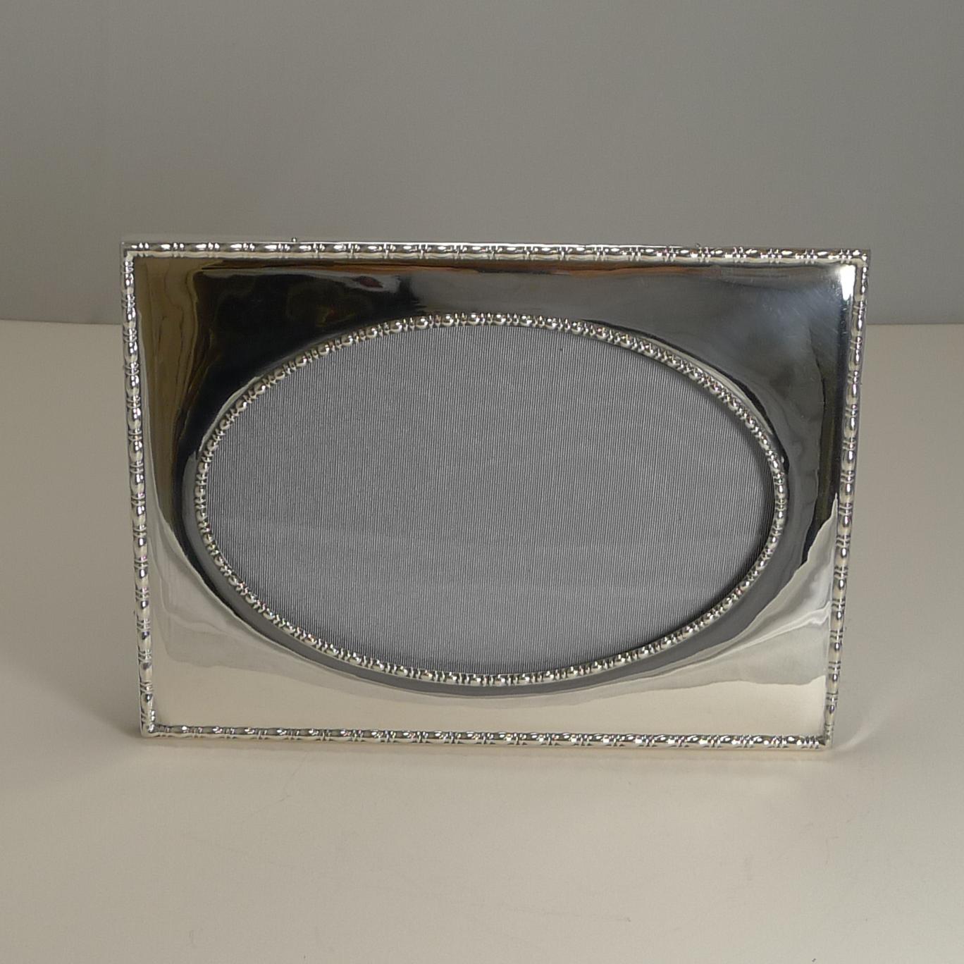 A very smart antique photograph frame made from English sterling silver with a fabulous raised border to the outer edge and surrounding the oval aperture.

This is a two-way picture, highly sought-after, being able to use it in either a landscape