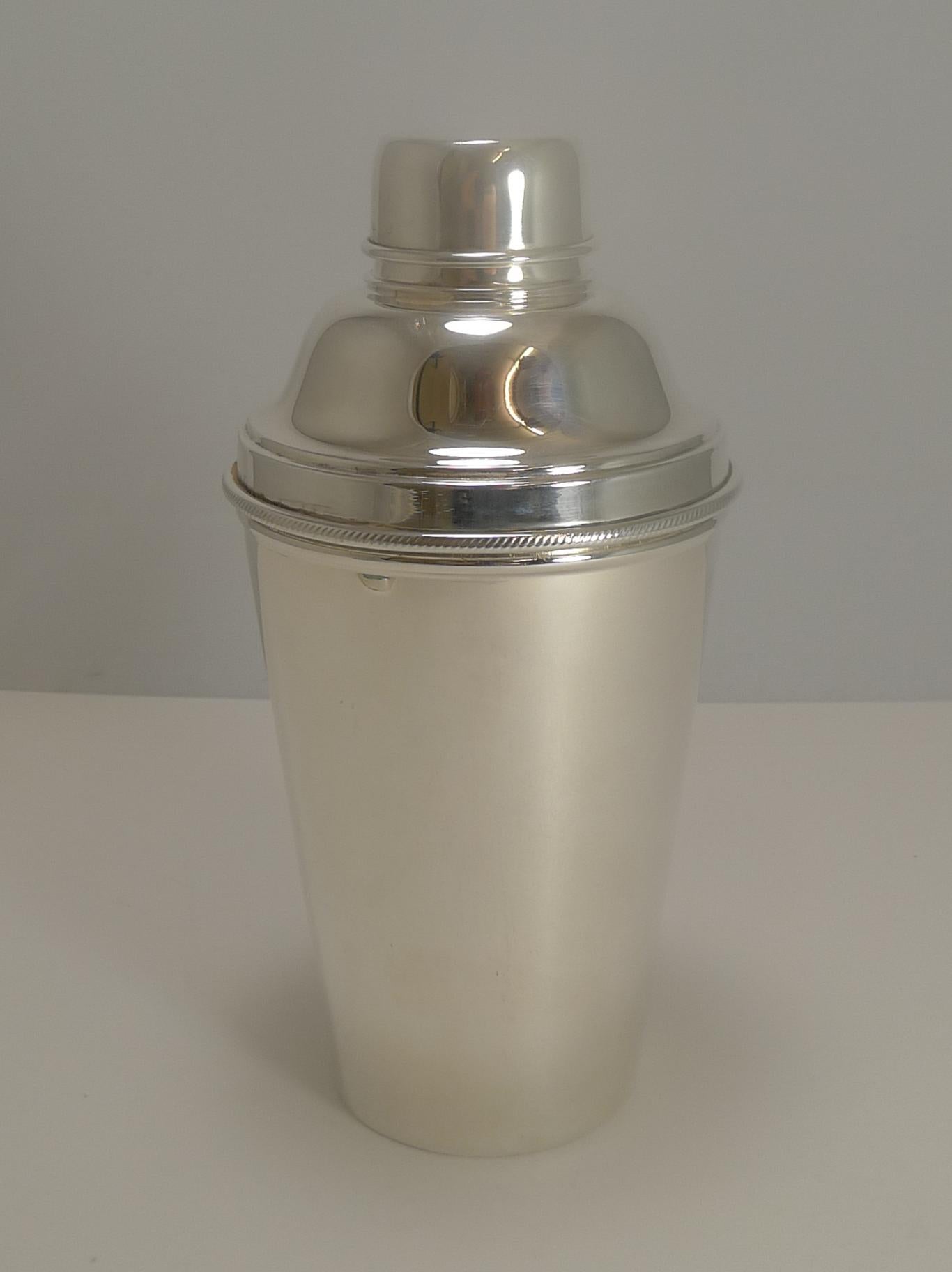 A fine large Art Deco cocktail shaker made from EPNS (Electro-plated nickel silver).

These examples are hard to find with the addition of an integrated lemon squeezer within the top; highly sought-after.

This one has to be one of the best we