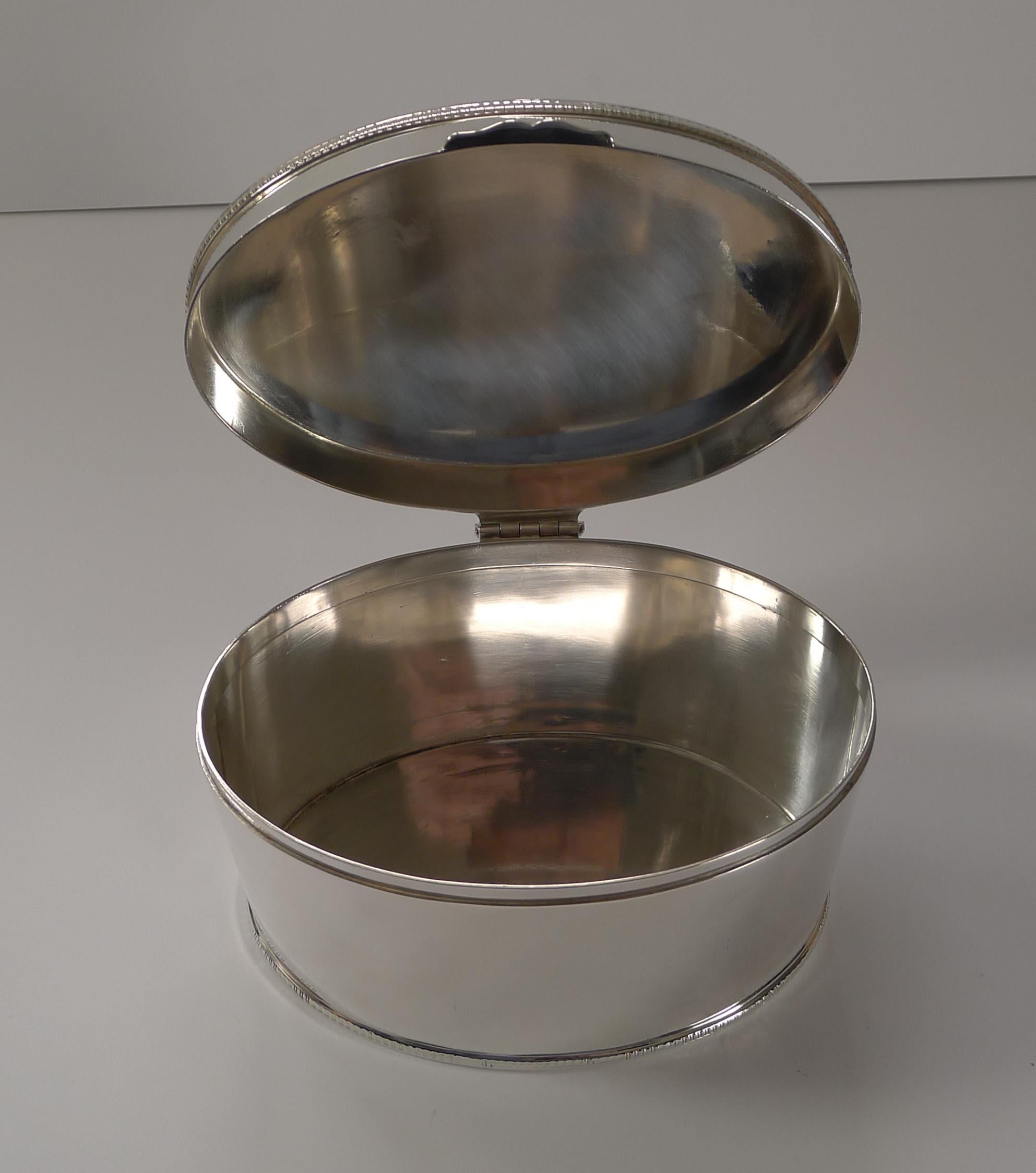 A fabulous antique English silver plated biscuit box of ovoid form with a hinged lid; simple and as fashionable today as it would have been over 100 years ago.

Just back from our silversmith's workshop where it has been professionally cleaned and