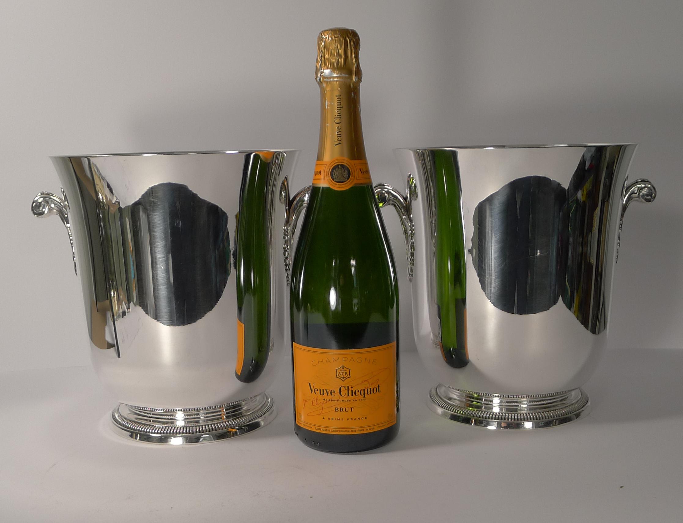 A wonderful pair of vintage wine coolers / Champagne buckets made by the highly prized silversmith, Maison Ercuis.

The simple shape stands on a beaded foot and has two fabulous Art Deco style handles. The underside is where the signature 