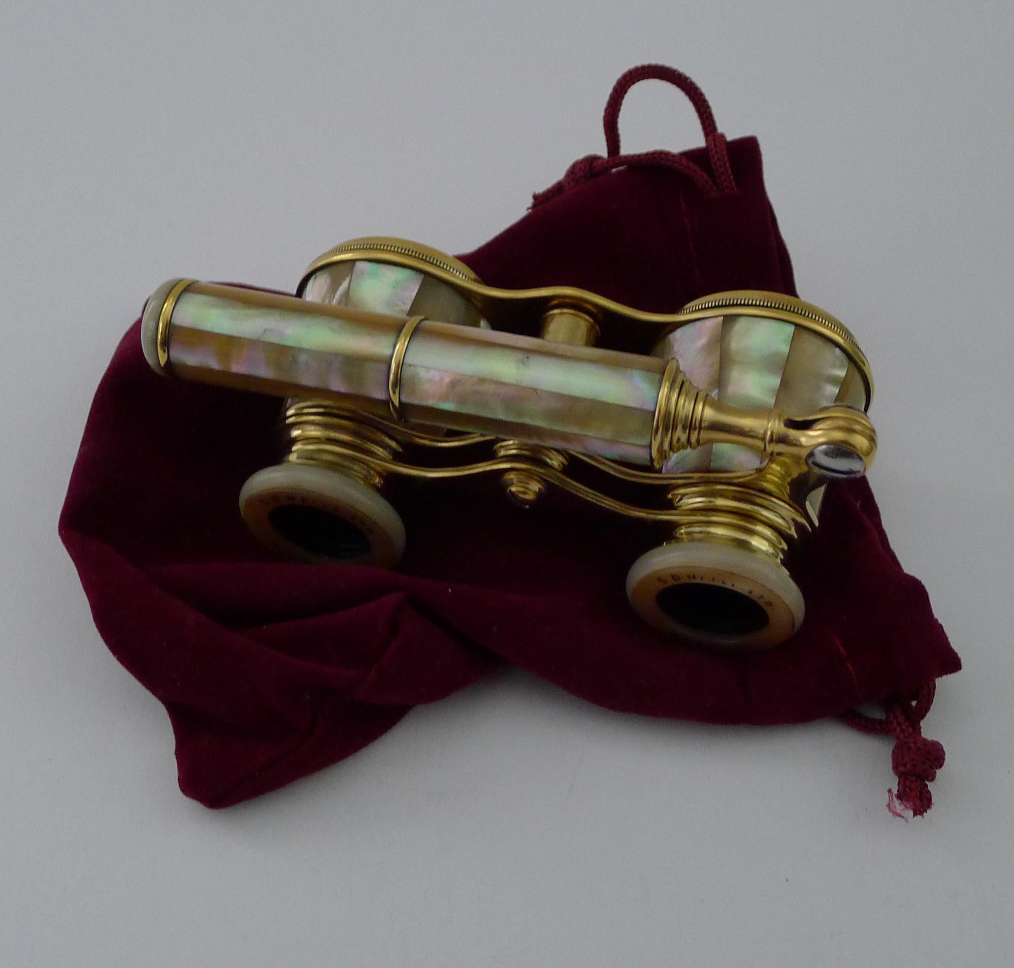 A handsome pair of French-made Opera glasses clad in magical Mother of Pearl or Nacre shell with it's luminous and iridescent qualities.

This pair was made for a Northern Irish Opticians, engraved and inked on the eye pieces. S D Neill Ltd,