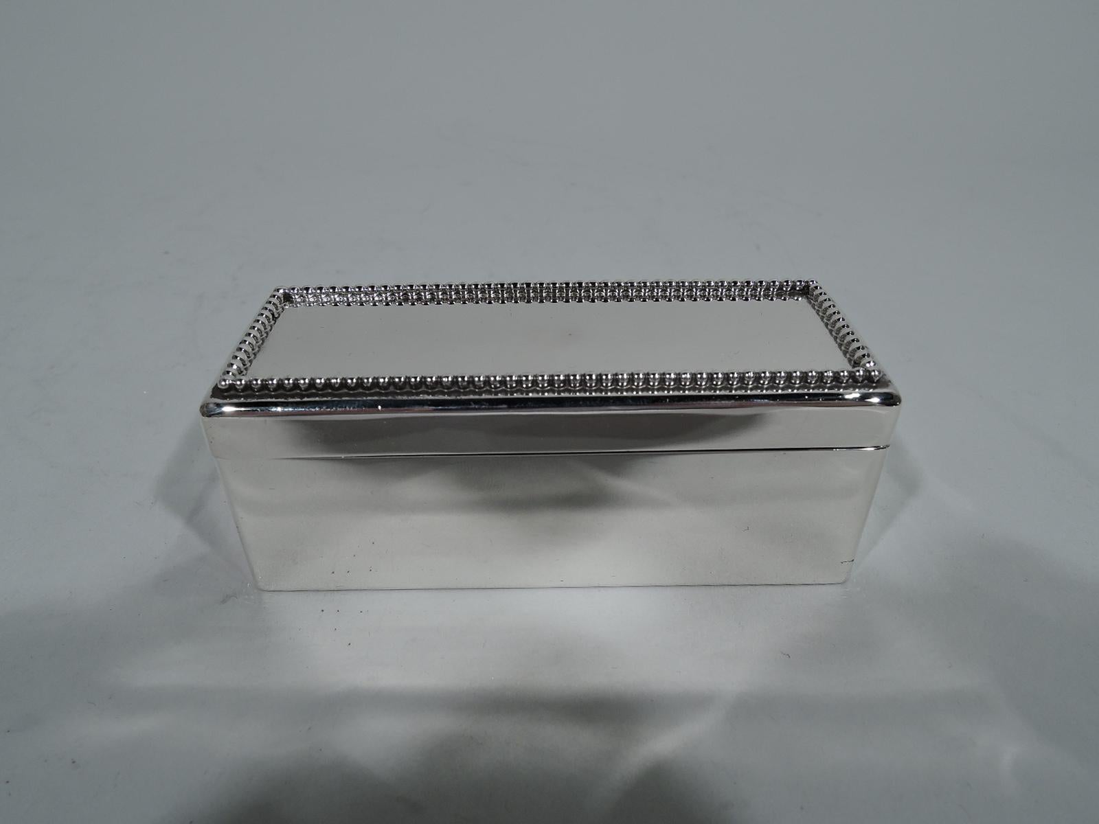 Smart sterling silver trinket box. Made by Gorham in Providence in 1899. Rectangular with straight sides and well-defined corners. Cover has inset beaded border. Interior gilt washed. Hallmark includes date symbol and no. 9396. Weight: 4 troy ounces.