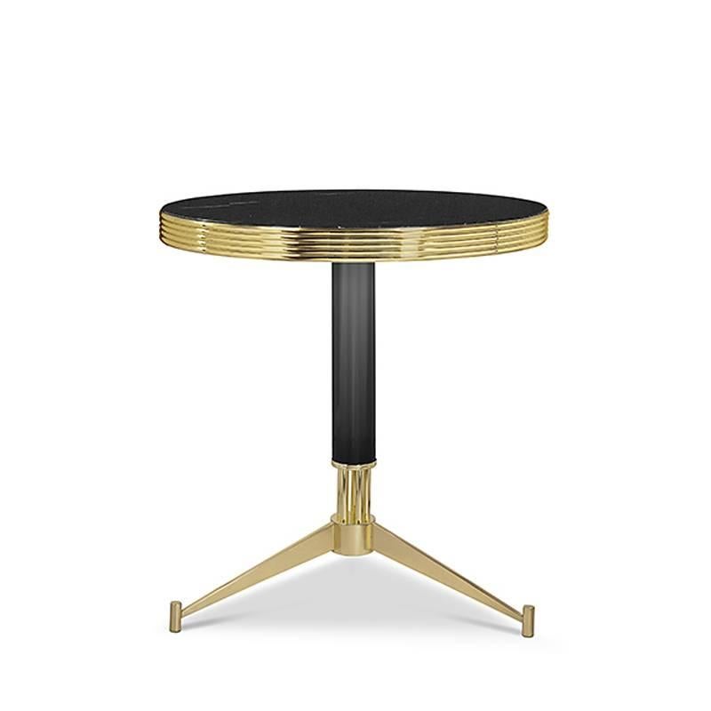 Side table smartly with black marble top.
With gold-plated brass rim. With black lacquered
feet and three gold-plated feet.