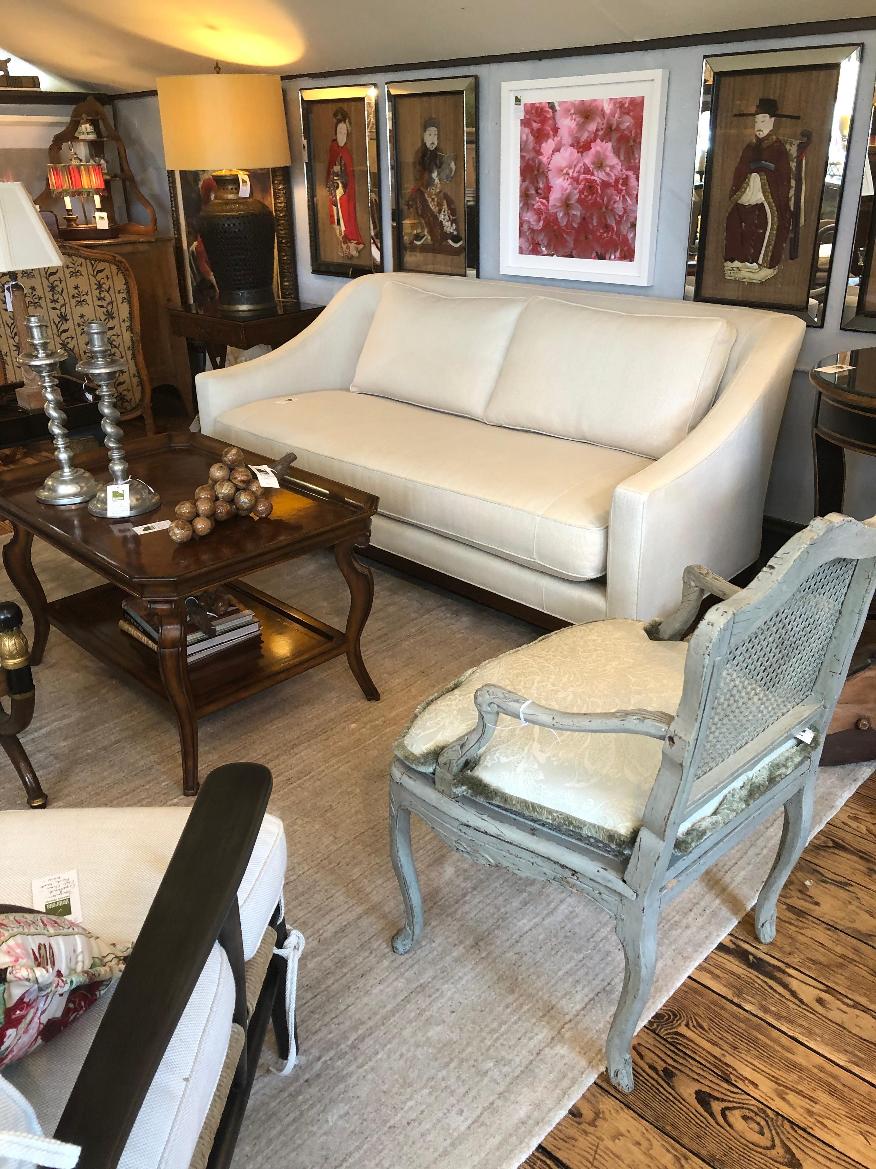 Like new stunning glamorous off white upholstered sofa by Baker having single seat cushion and two back cushions with subtle buttons on the inside back.
74 W at back
77.5 W arm to arm
interior seat 68 W, 29 D
seat height 18.25.