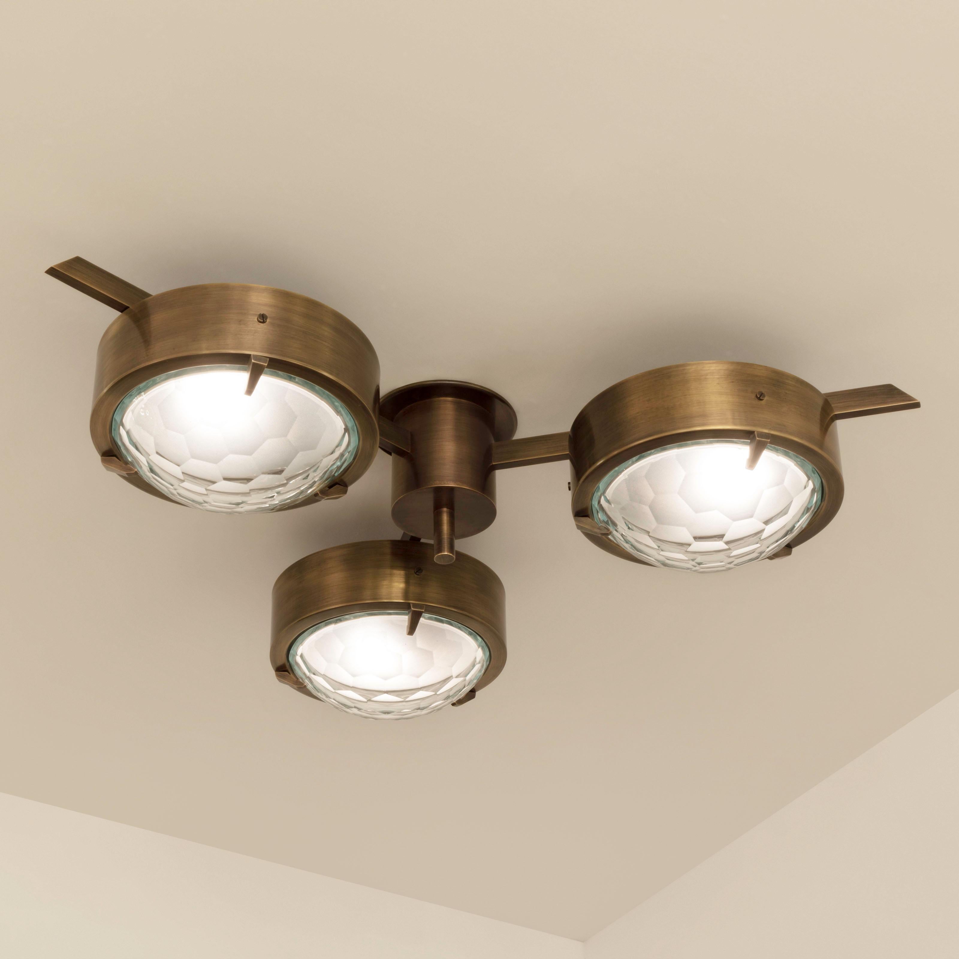 The Smeraldo ceiling light features three shades hand faceted from thick starphire glass, balanced on a brass machined frame. Shown as a flush mount in our bronzo ottone finish. Listed price is for the stock model in polished brass.

Customization