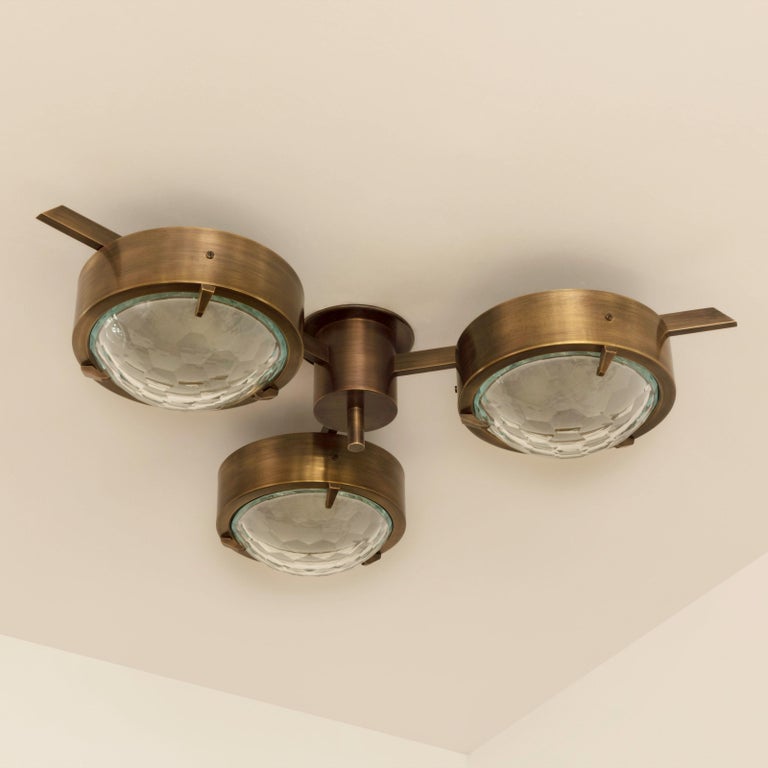 The smeraldo ceiling light features three shades hand faceted from thick starphire glass, balanced on a brass machined frame. Shown as a flush mount in our bronzo ottone finish. Listed price is for the stock model in polished brass.

Customization