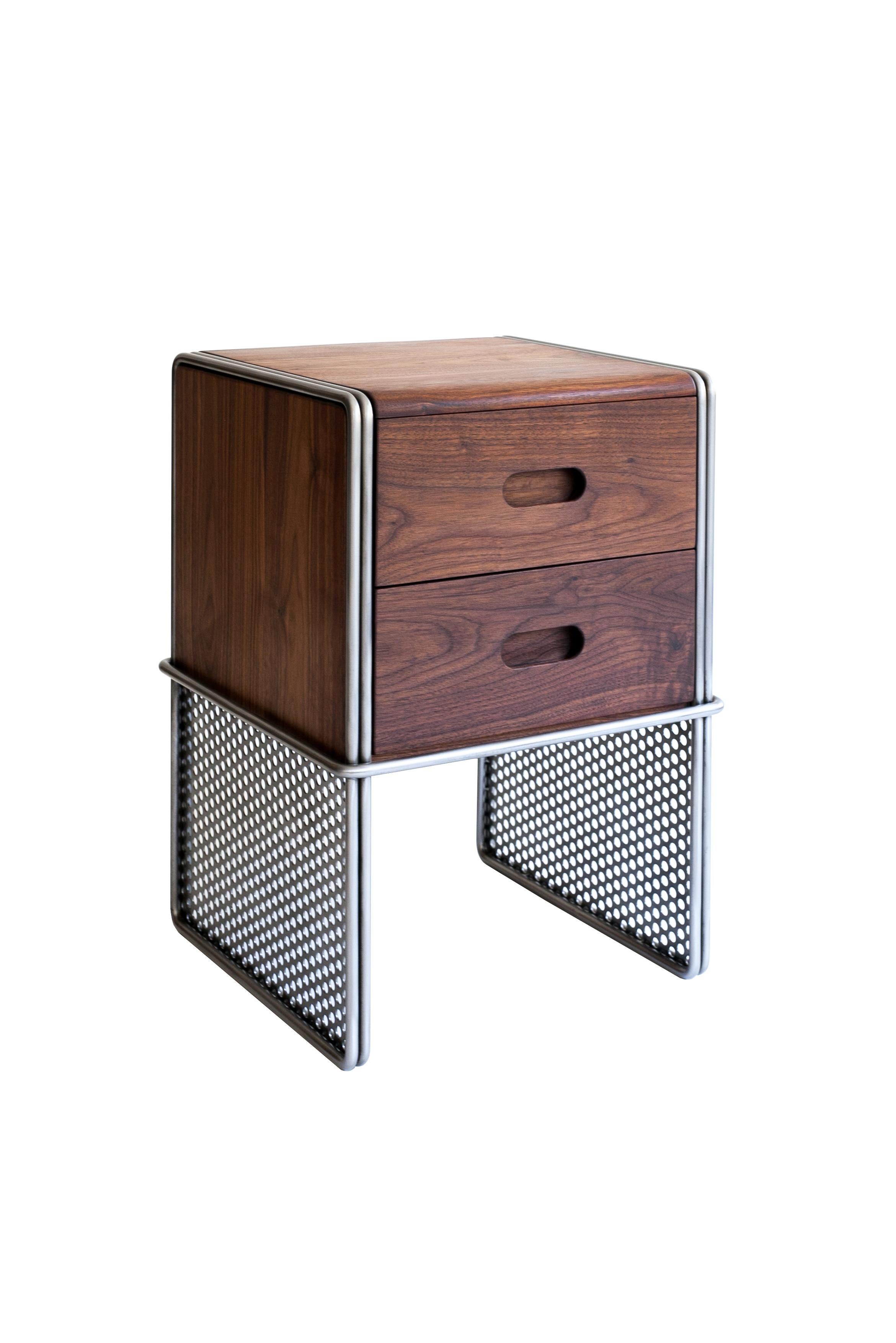 The Smith & Wesson double drawer is an Industrial Mid-Century Modern style bedside table or office storage unit. The wood is encased in a signature-style metal frame. Inspired by gun handles and hollowed features of bullet-ridden metal sheets. The