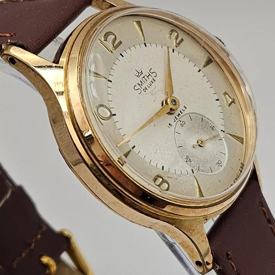 Smiths De Luxe All English 9ct Gold Mens Watch with Arabic Numerals 15 jewels

Case diameter 32mm and is 9ct solid gold plated with a screw in back. The thickness is 10.4mm. Dial and hands are excellent. The strap is a long fitting dark brown calf