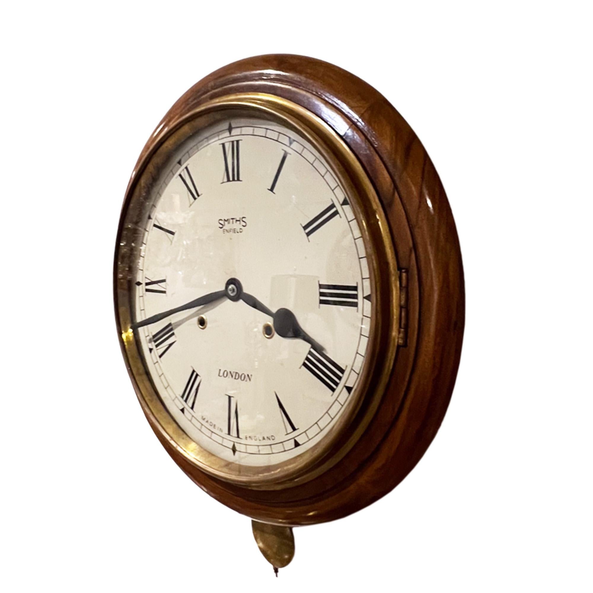 This is a charming wall clock made in Enfield, London in the early 20th century. 

It works perfectly as we have had it cleaned and fully overhauled. The clock strikes beautifully on the hour and the half hour. 

Made from walnut and we have the
