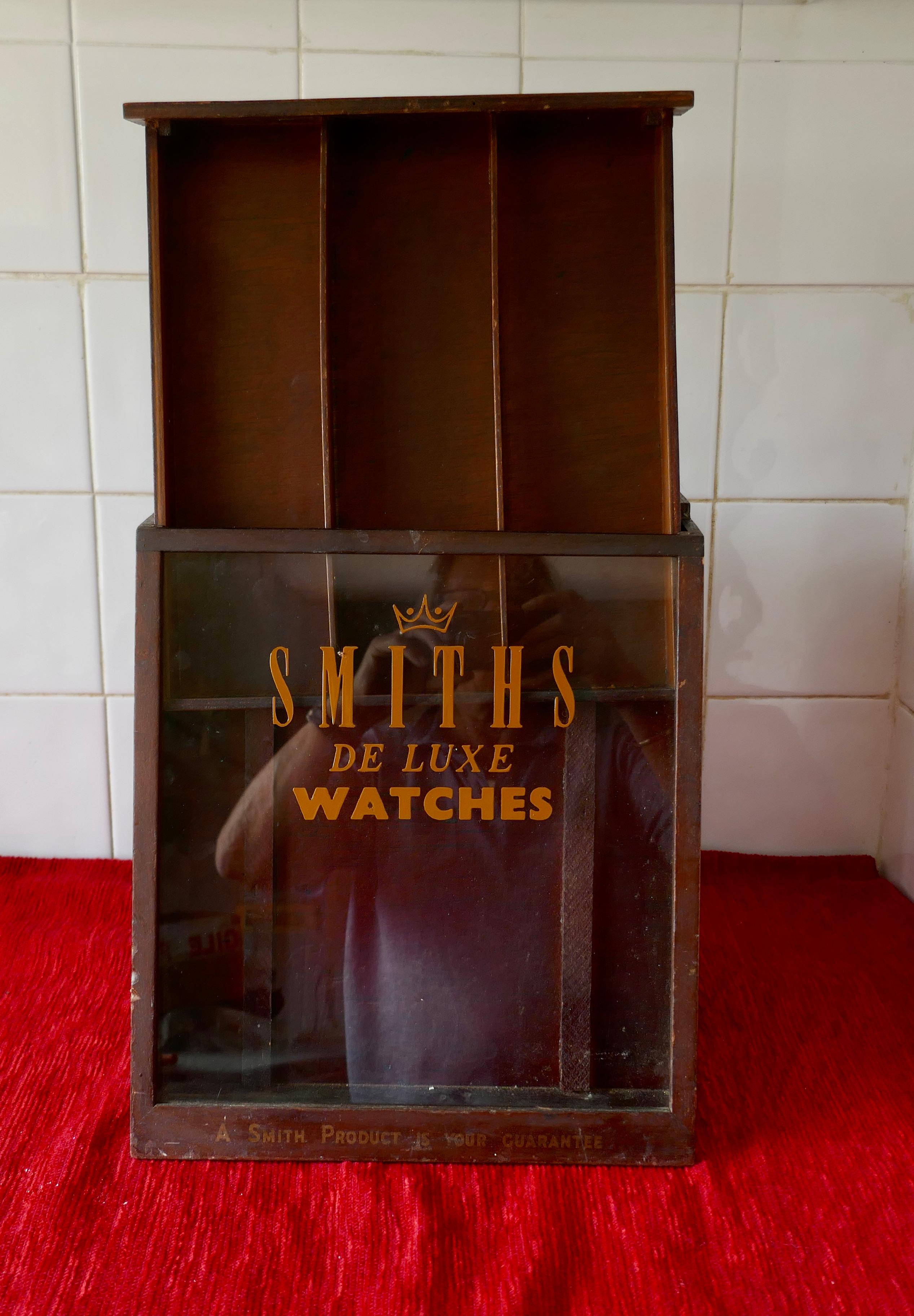 Smiths Watchmakers shop display cabinet

A lovely piece, the cabinet has been made to sit on a shop counter
The interior has 3 long drawers accessed from the back and a glazed sloping front section . This is divided into 3 and Has the iconic