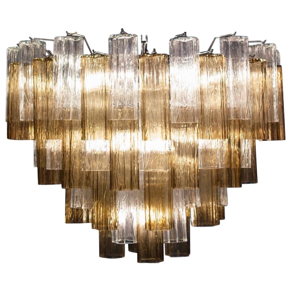 This striking chandelier is composed by 78 smoke and ice color Murano glass 'Tronchi'
by 20 cm high. 
Ten E 27 light bulbs. 
Measures: Height without chain (cm 60) inches 23,60 with chain (cm 110) inches 43
Weight 50 kg circa.
 price is for one