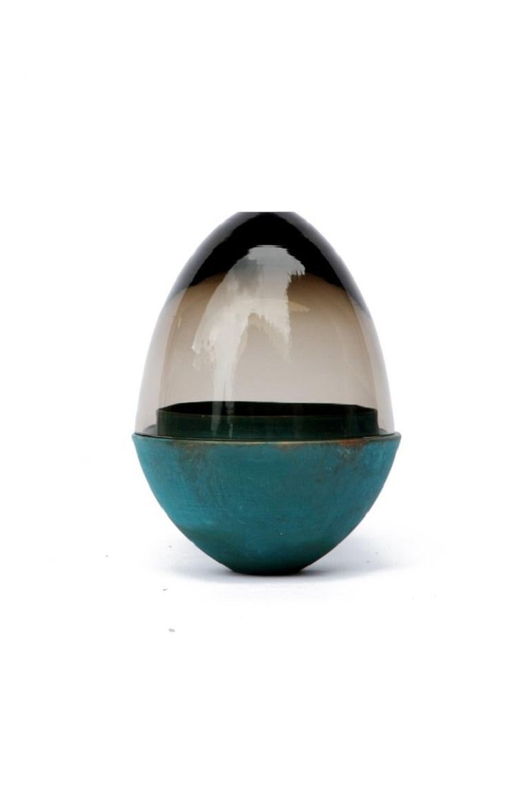 Smoke and copper patina homage to Faberge jewellery egg, Pia Wüstenberg
Dimensions: D 13.5 x H 20.
Materials: glass, copper.
Available in other metals: copper, copper patina.

The contemporary reinterpretation of the famous jewellery