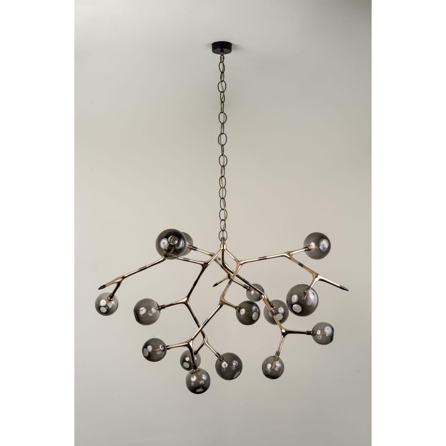 Smoke and Polished Bronze Maratus 15 Pendant Lamp by Isabel Moncada
Dimensions: Ø 135 x H 160 cm.
Materials: Cast bronze, blown glass and turned brass.
Weight: 20 kg.

The image of a swarm of small lights at night is mesmerizing. Maratus 15 is a