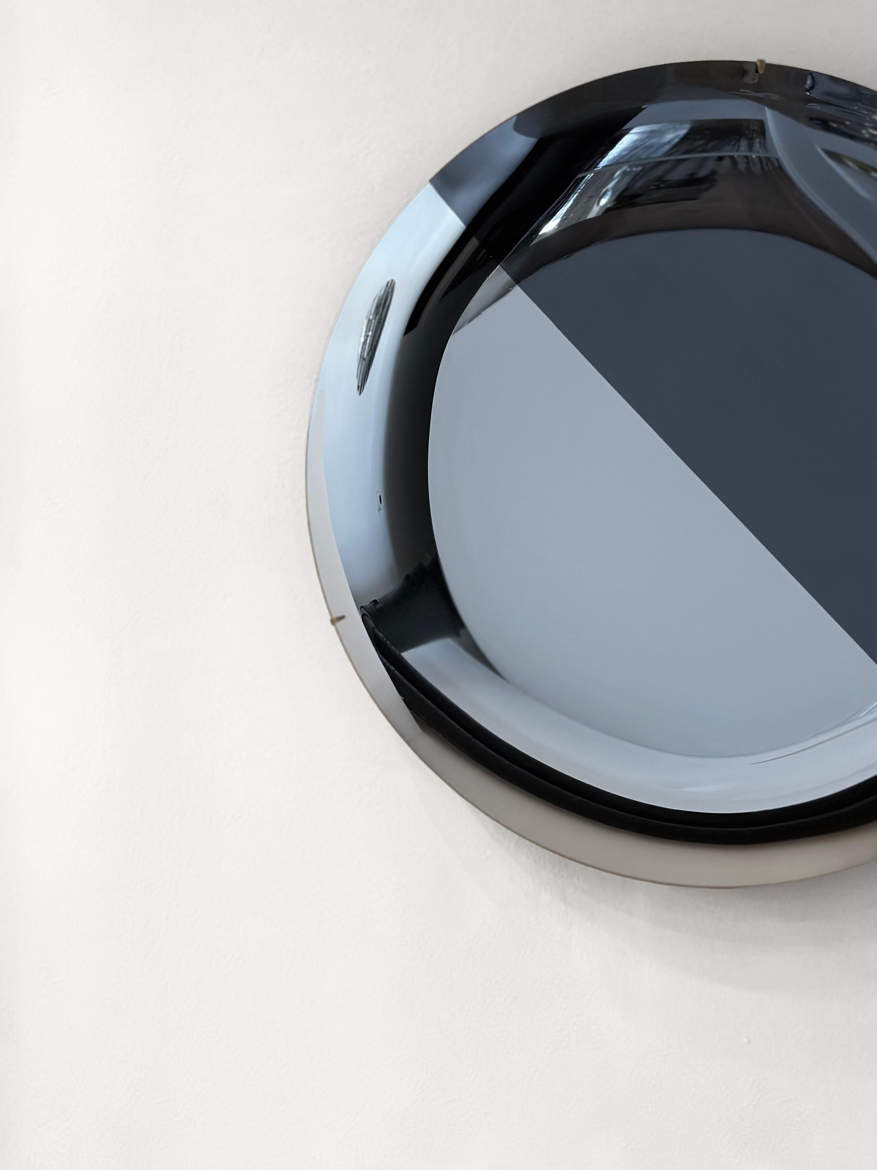 Concave Smoke and Silver Mirror.
Ø97 cm  Depth: 7 cm  Thickness: 4 mm 
Colour: Silver and Smoke  Hanger: Brass


The Smoke & Silver Collection
The SMOKE & SILVER Collection draws the viewer into shifting depths of reflection. Their circular forms