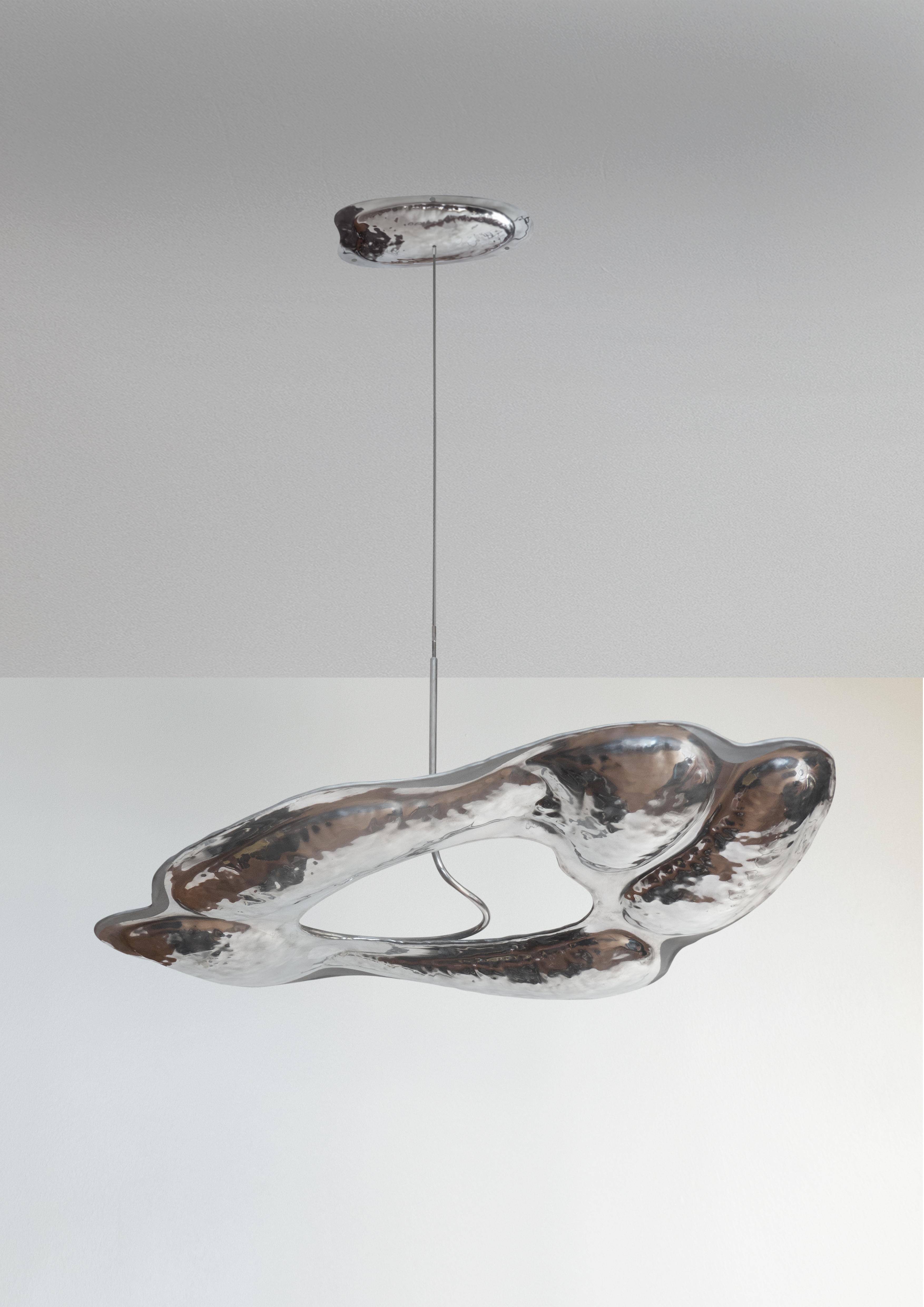 Smoke cloud chandelier by Christian and Jade
Smoke cloud chandelier
Year: 2020
Material: Hammered aluminium
Size: H 50, L 80, W 65 cm and adjustable length or to size

Smoke cloud chandelier is an oil lamp that floats mid space, cap-
Turing