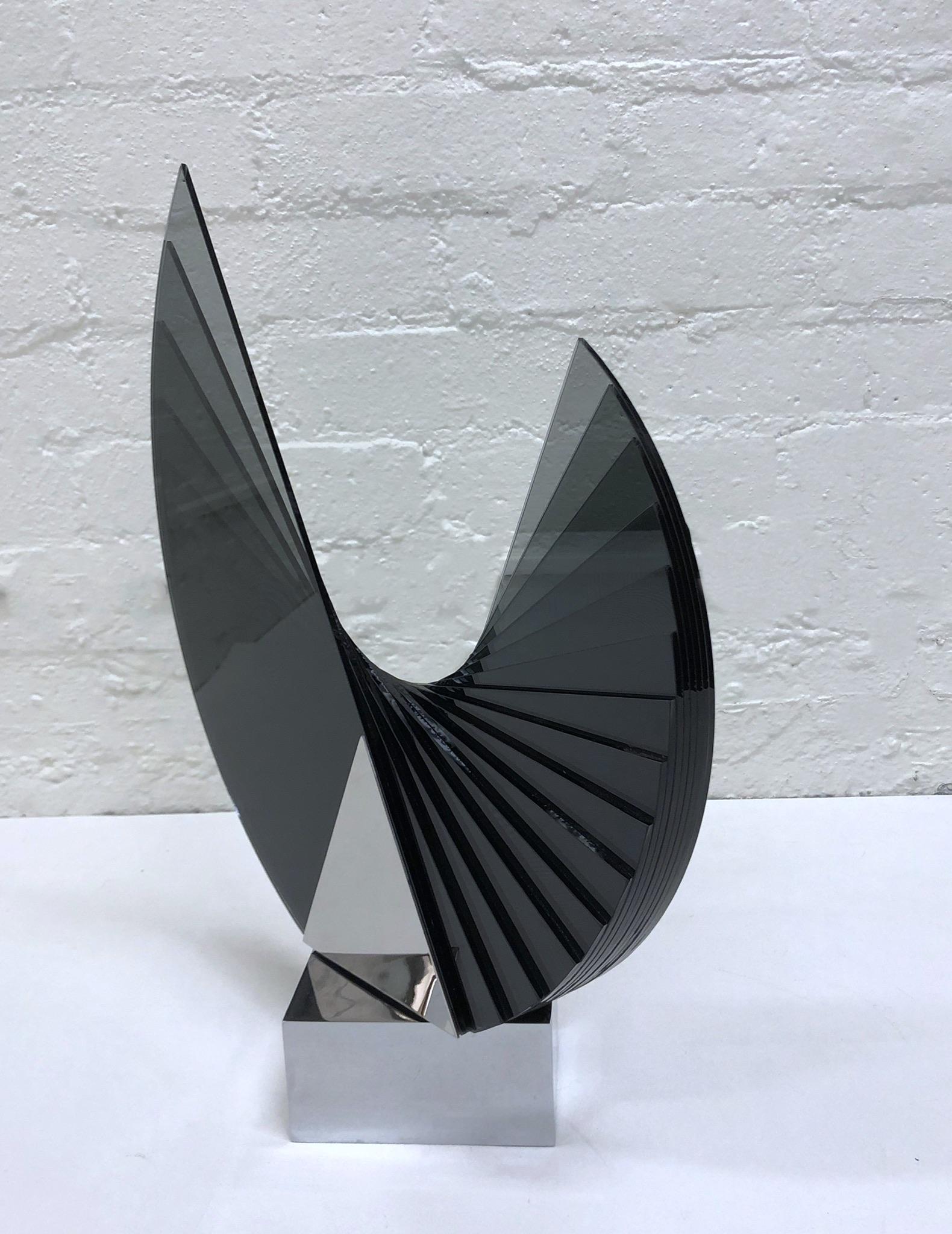 Gray smoked layered glass and polish chrome rotating sculpture by Kurt and Marsha Runstadler for Runstadler Studios. 
Signed @ 1990 Runstadler Studios 5/30
The top glass section of the sculpture can be rotated 360 degrees. 
Measurements: 22.25”