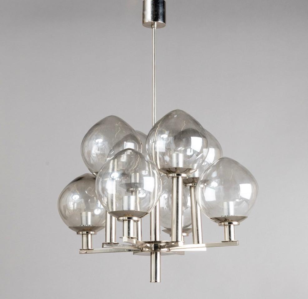8 shade mouth blown glass chandelier of smoke grey glass and chrome design attr. to Hans Agne Jakobsson. This piece was purchased in Sweden. 
The lampshades are slightly pointed and of an artisanal quality, making it a high-quality object that
